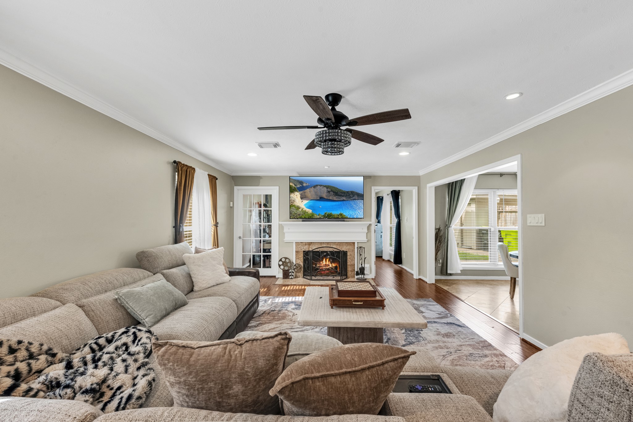 The family room offers an inviting, oversized layout centered around a beautiful fireplace, creating the perfect space for relaxing evenings or gathering with family and friends.