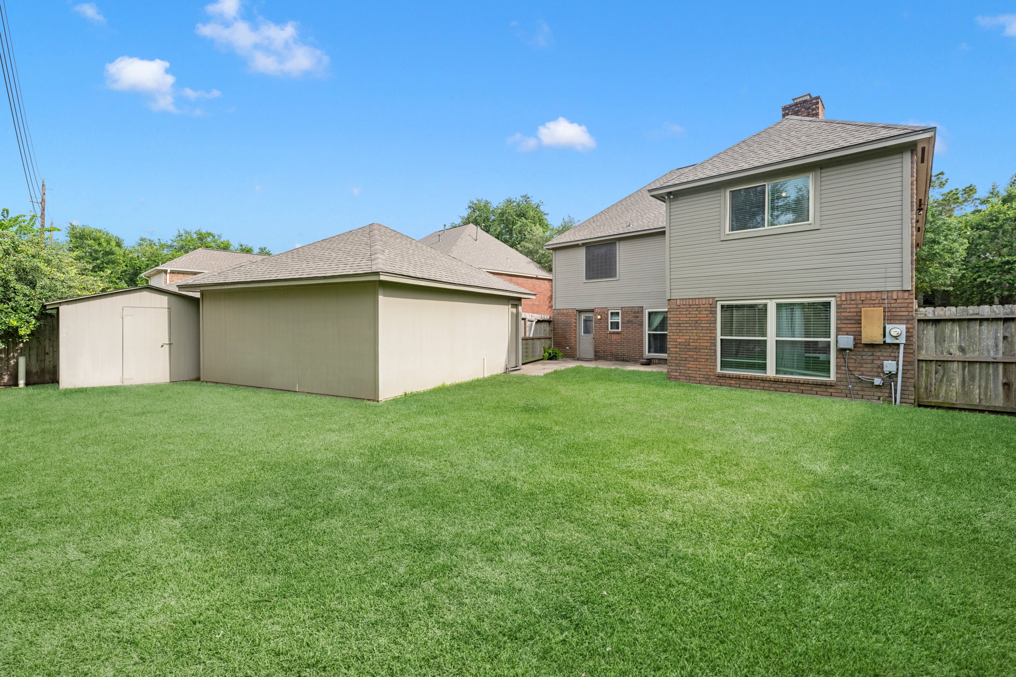 Large backyard with a dethatched garage is fully fenced, the patio offers the perfect space for grilling.