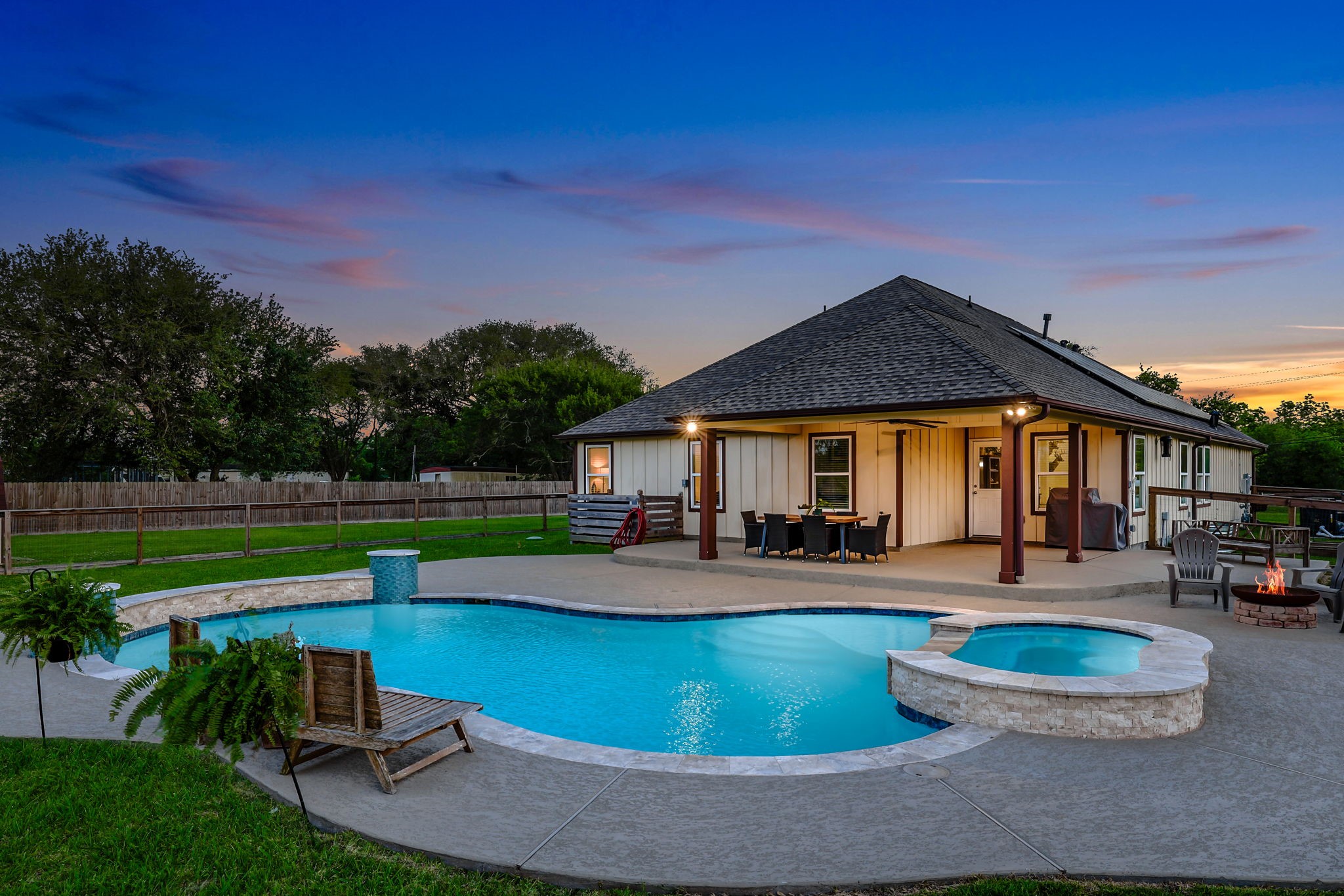 Experience the ultimate outdoor oasis with an oversized covered patio, sparkling pool, and inviting hot tub, perfect for relaxation and entertaining.