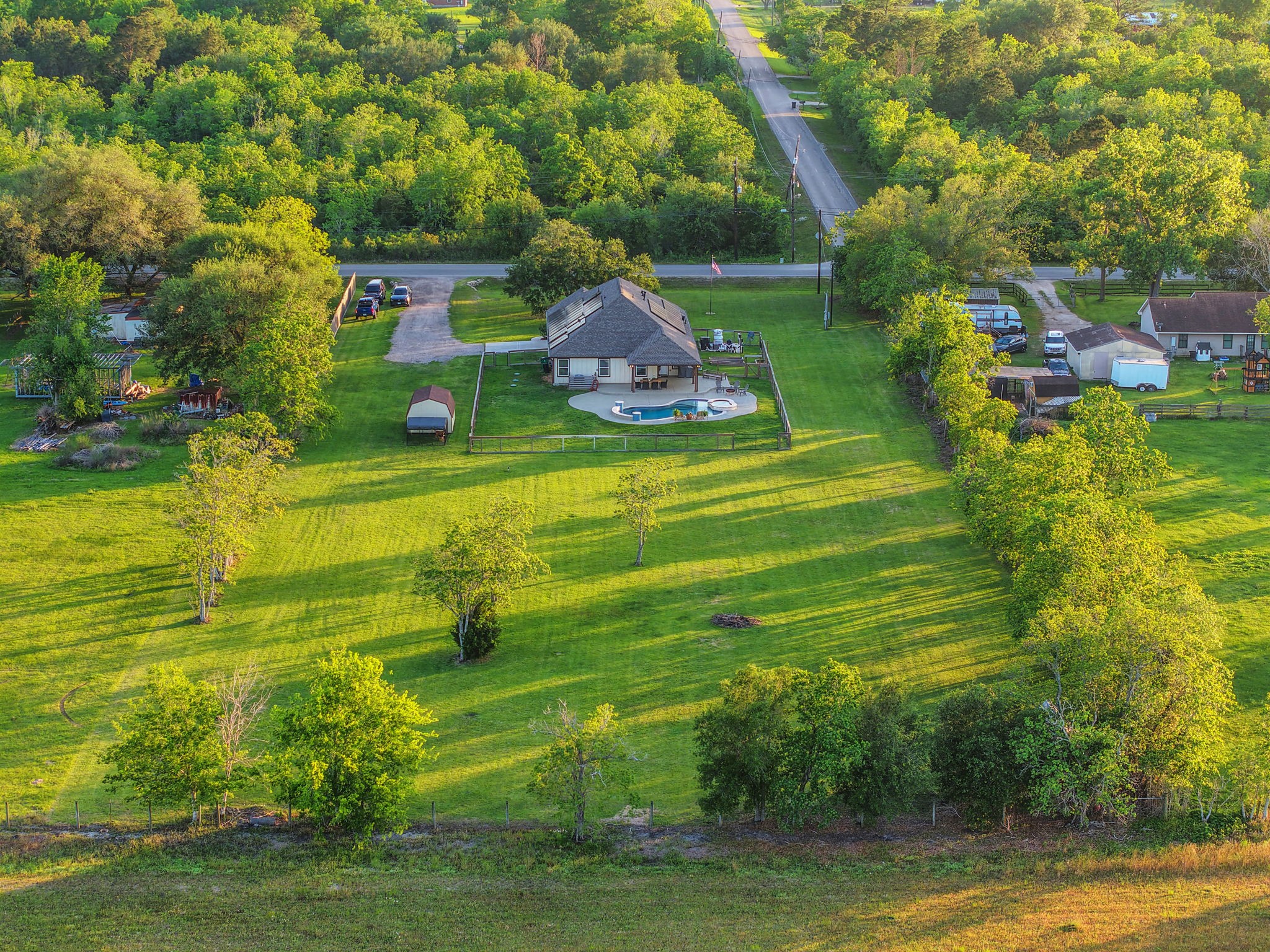 Charming home nestled in expansive greenery, featuring a private pool and spacious backyard, perfect for serene country living.