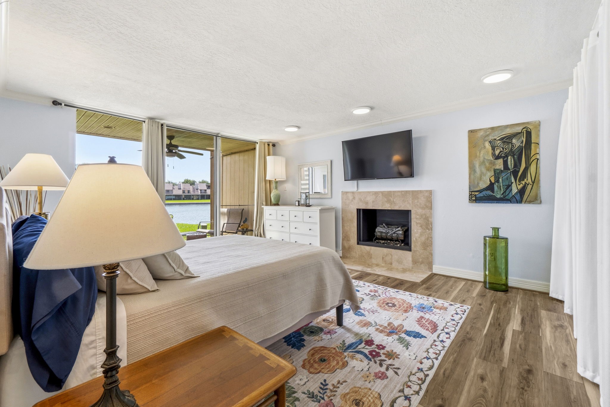 Wake Up to Lake Conroe Large primary suite with direct patio access, abundant natural light, and stunning waterfront scenery.