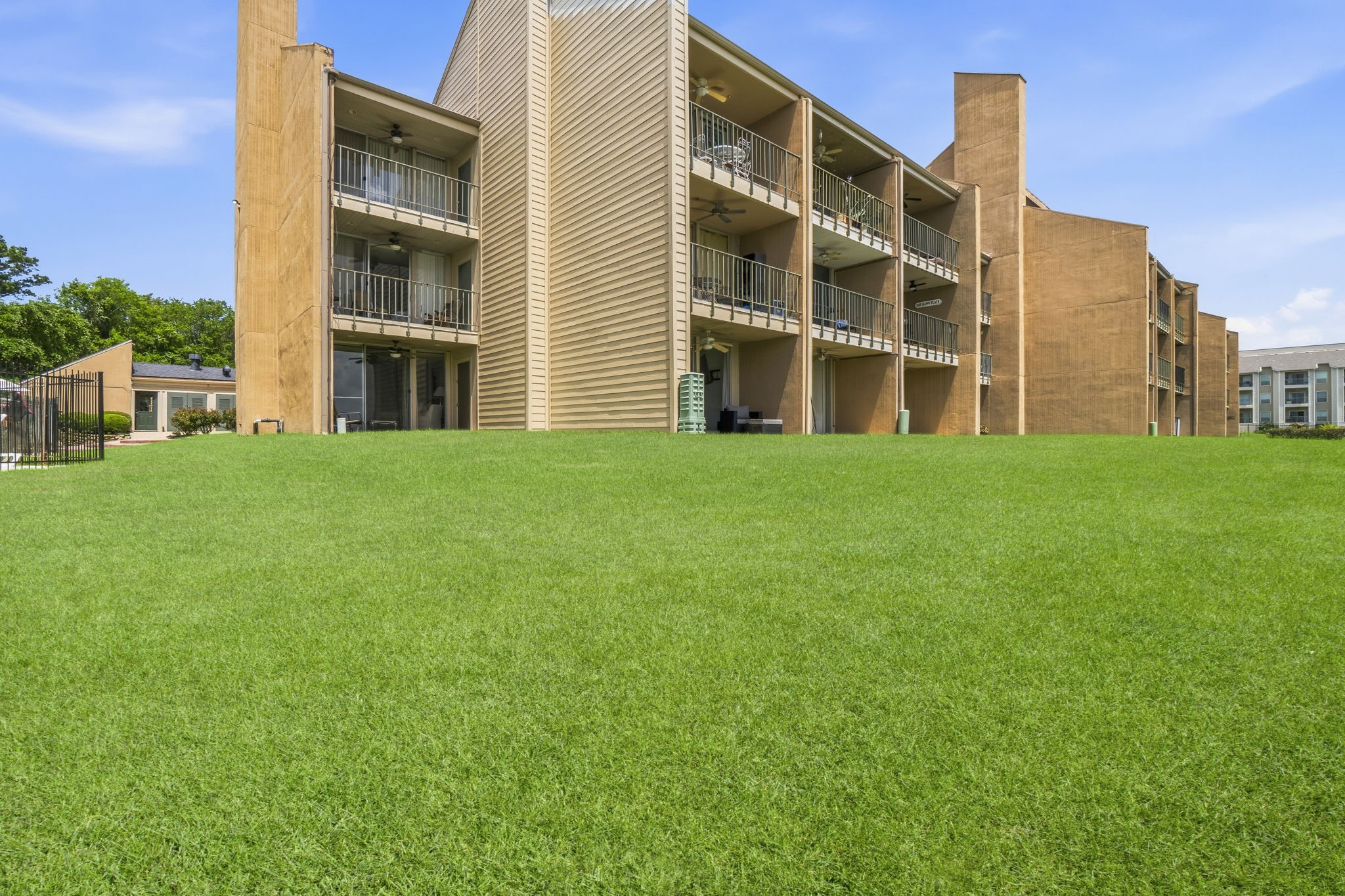 Lush green lawns stretch to the waters edge, creating a picturesque setting for outdoor enjoyment and unforgettable lake views.