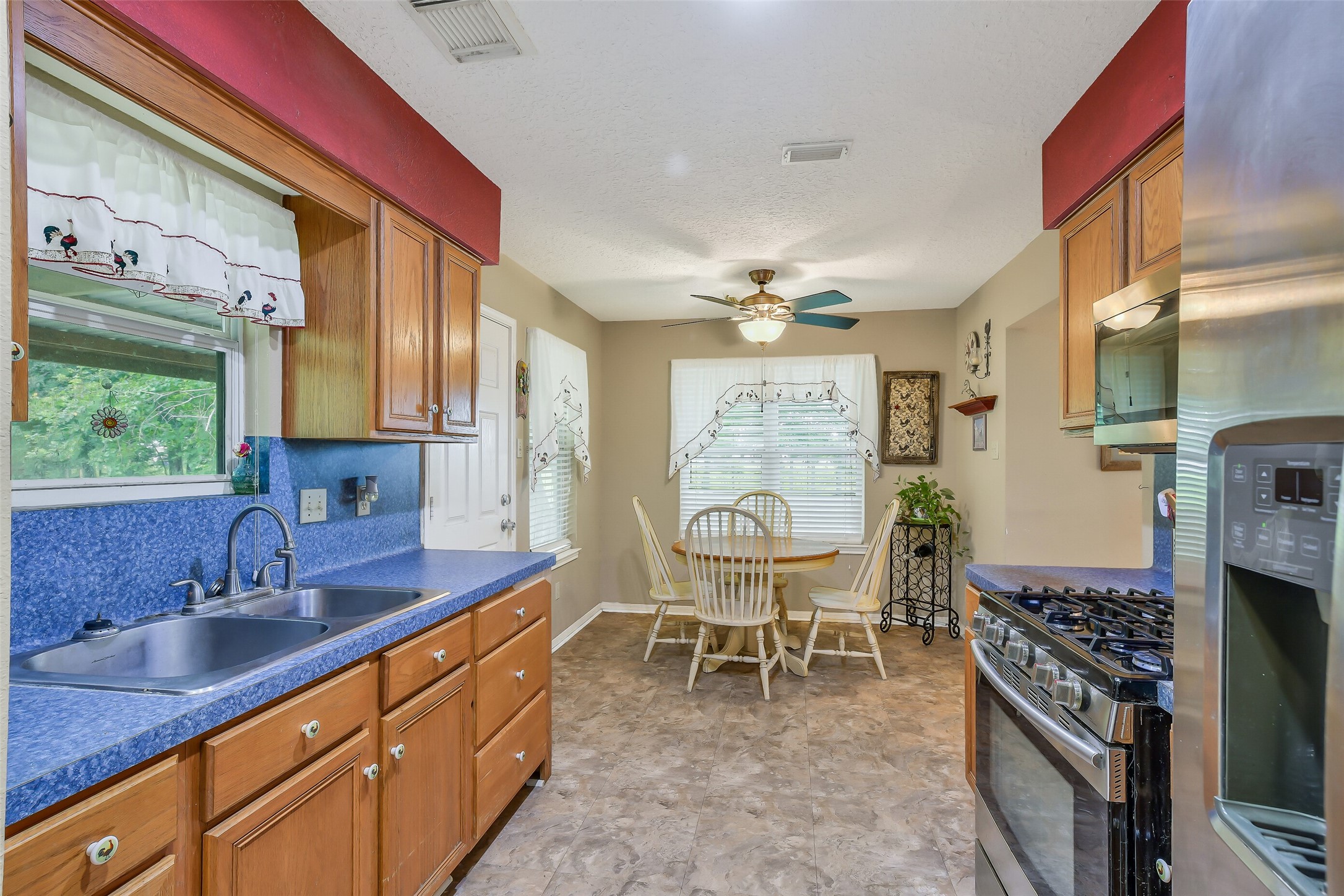 Stainless appliances stay as does the washer and dryer.