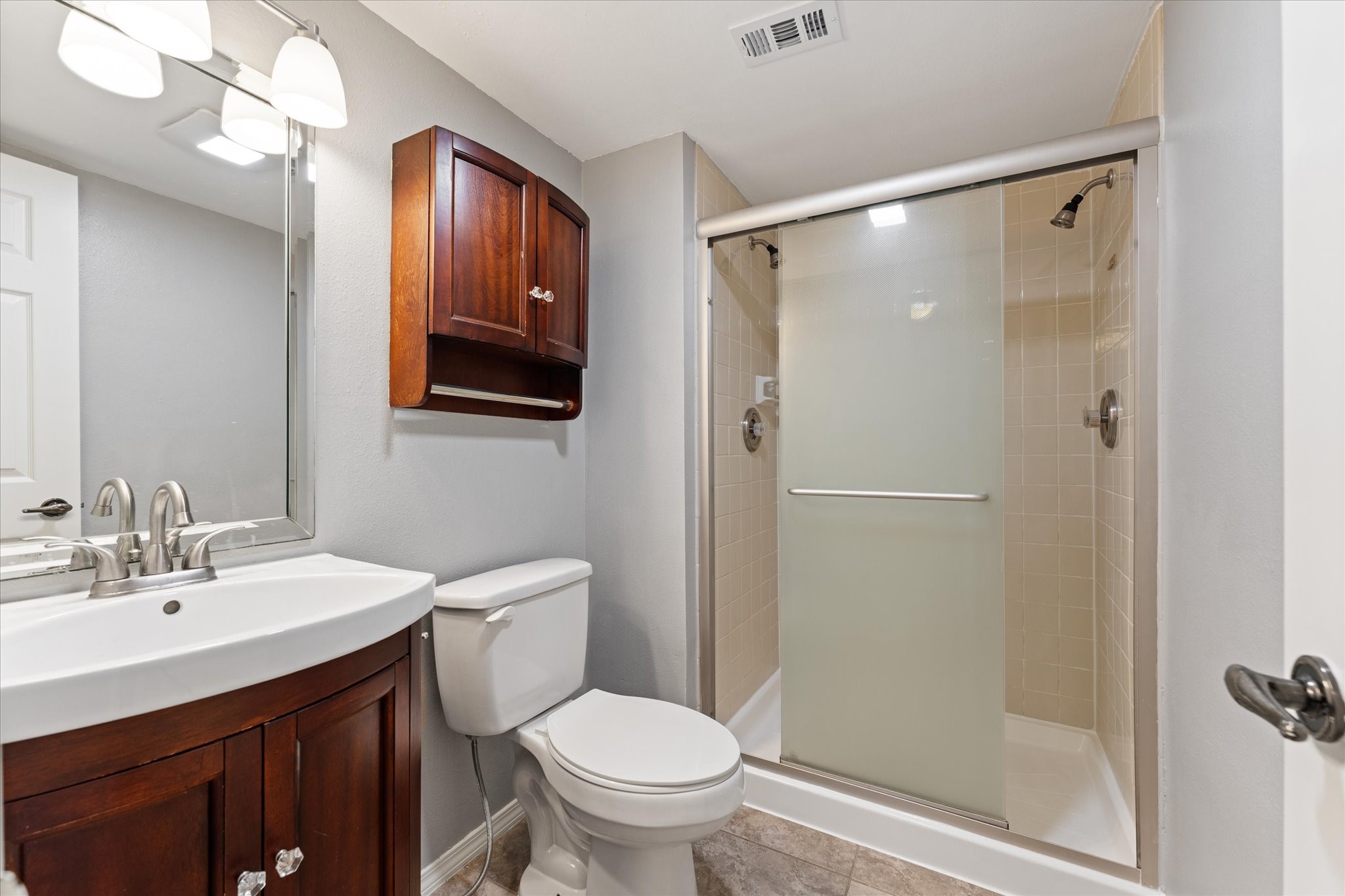 Full bath with 2 shower heads in shower