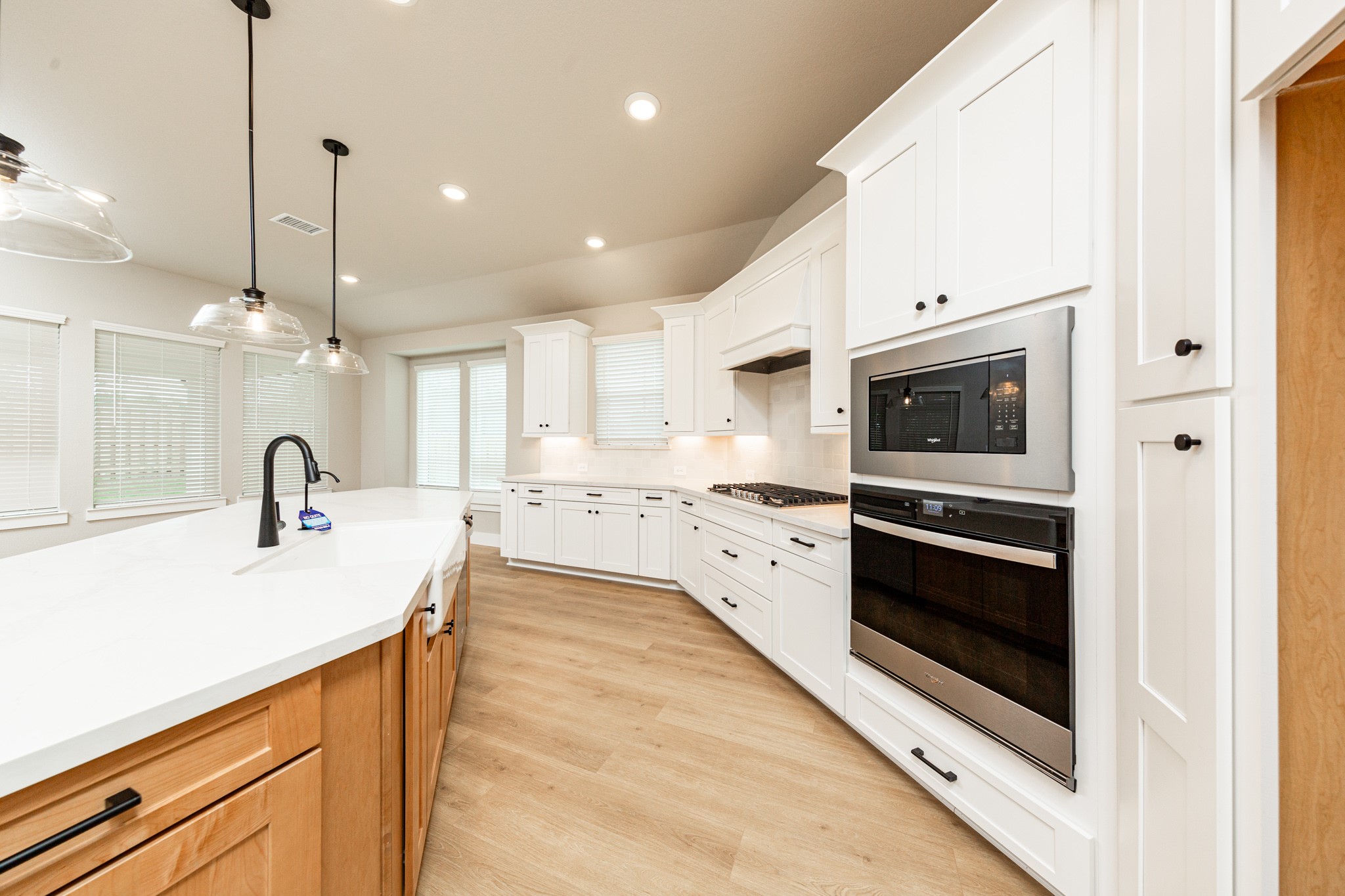 Discover the perfect blend of style and function in this modern kitchen, ready for your next culinary adventure. Equipped with high-end, stainless steel appliances, including a gas cooktop, built-in oven, and microwave.