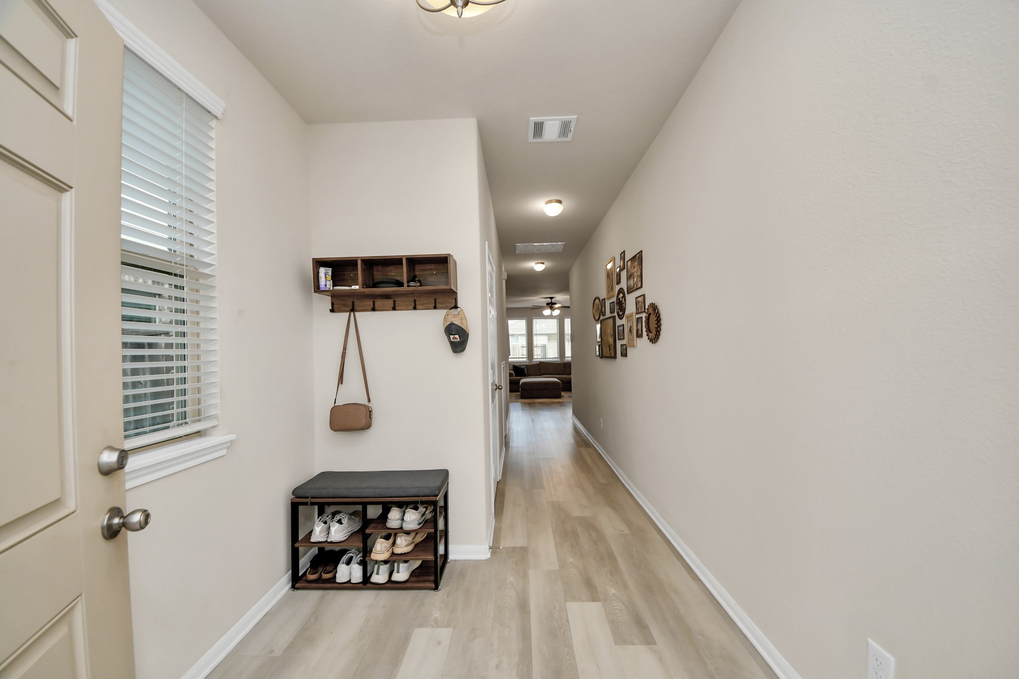 Welcoming entry with space for bag or shoe storage.