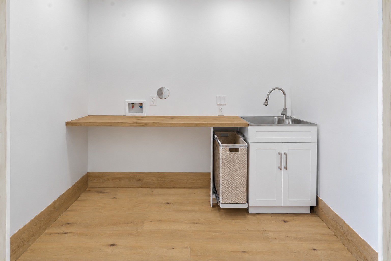 Dedicated laundry room w/ utility sink, ample folding counter space.