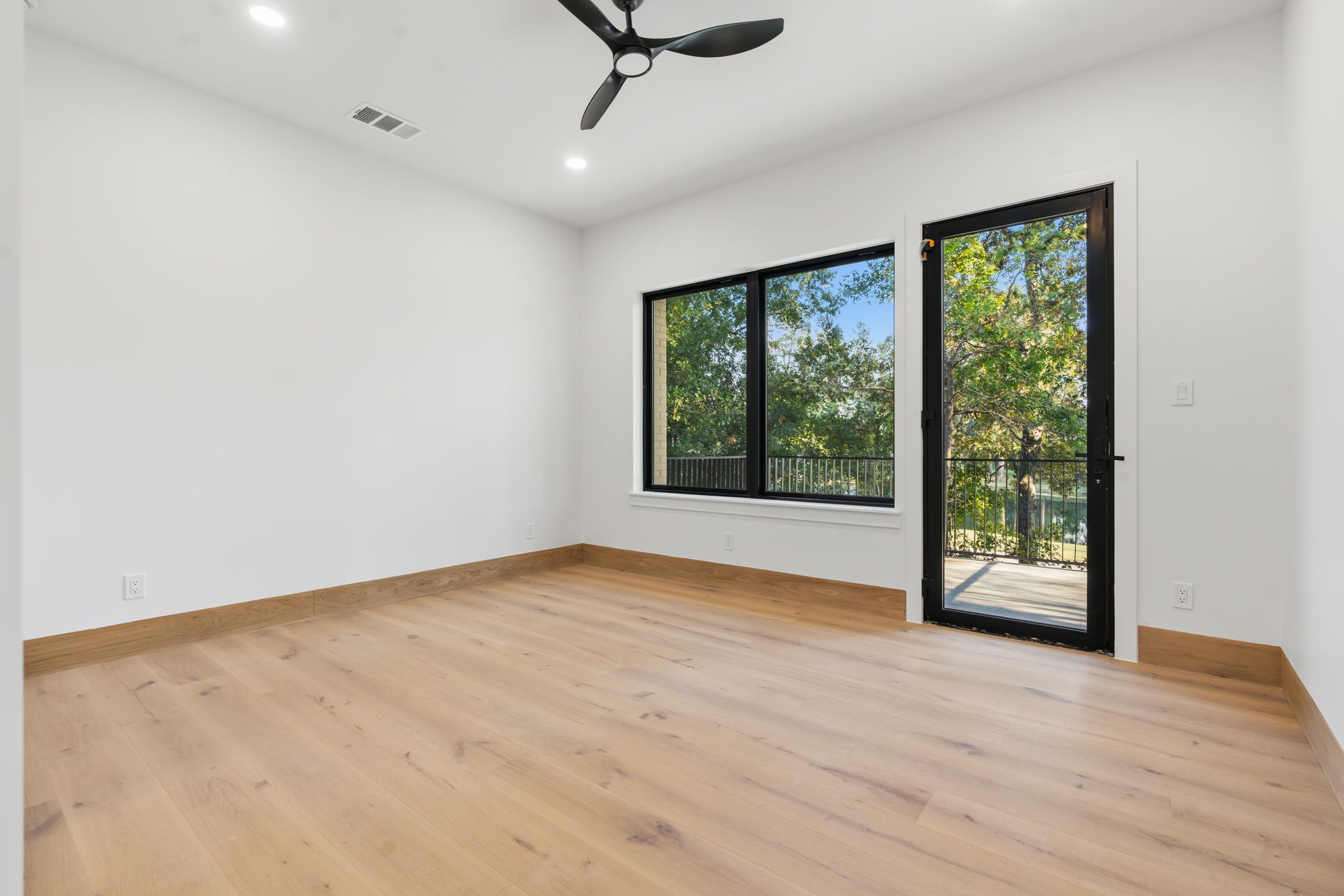 Spacious primary bedroom featuring a private balcony with stunning views