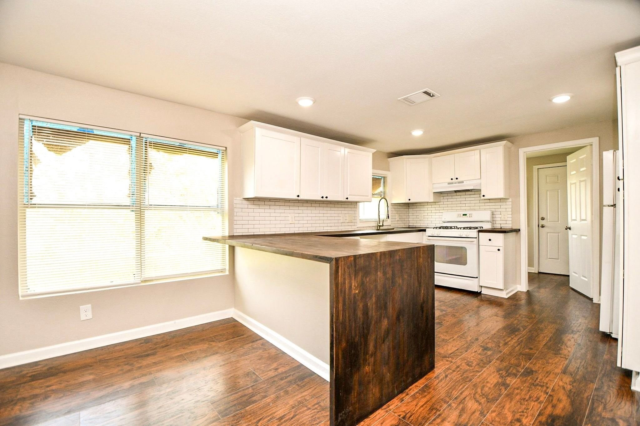 Kitchen with a spacious breakfast bar and ample cabinetry for all your cooking and storage needs.