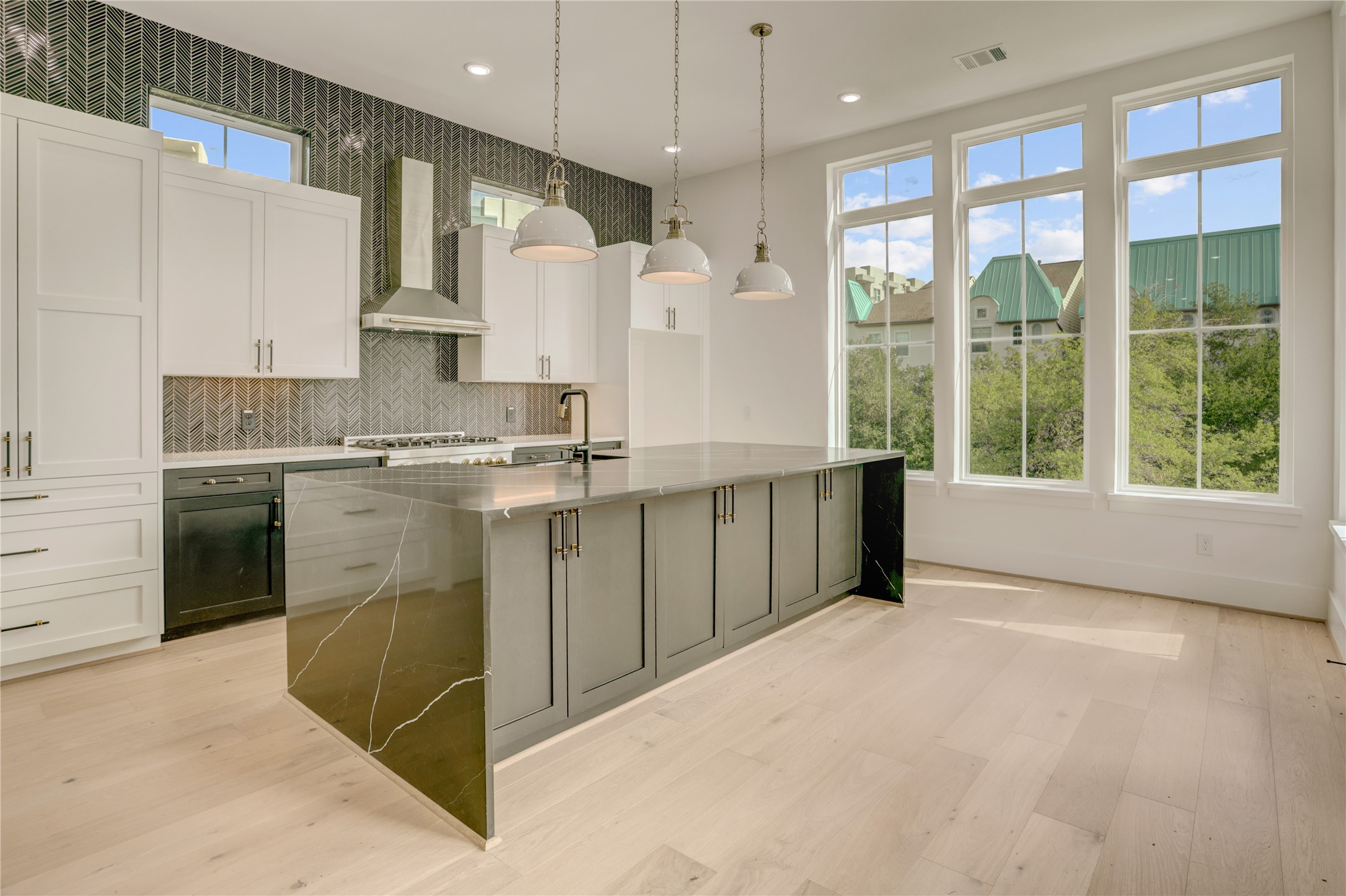 View of the island kitchen as you enter from the living room.