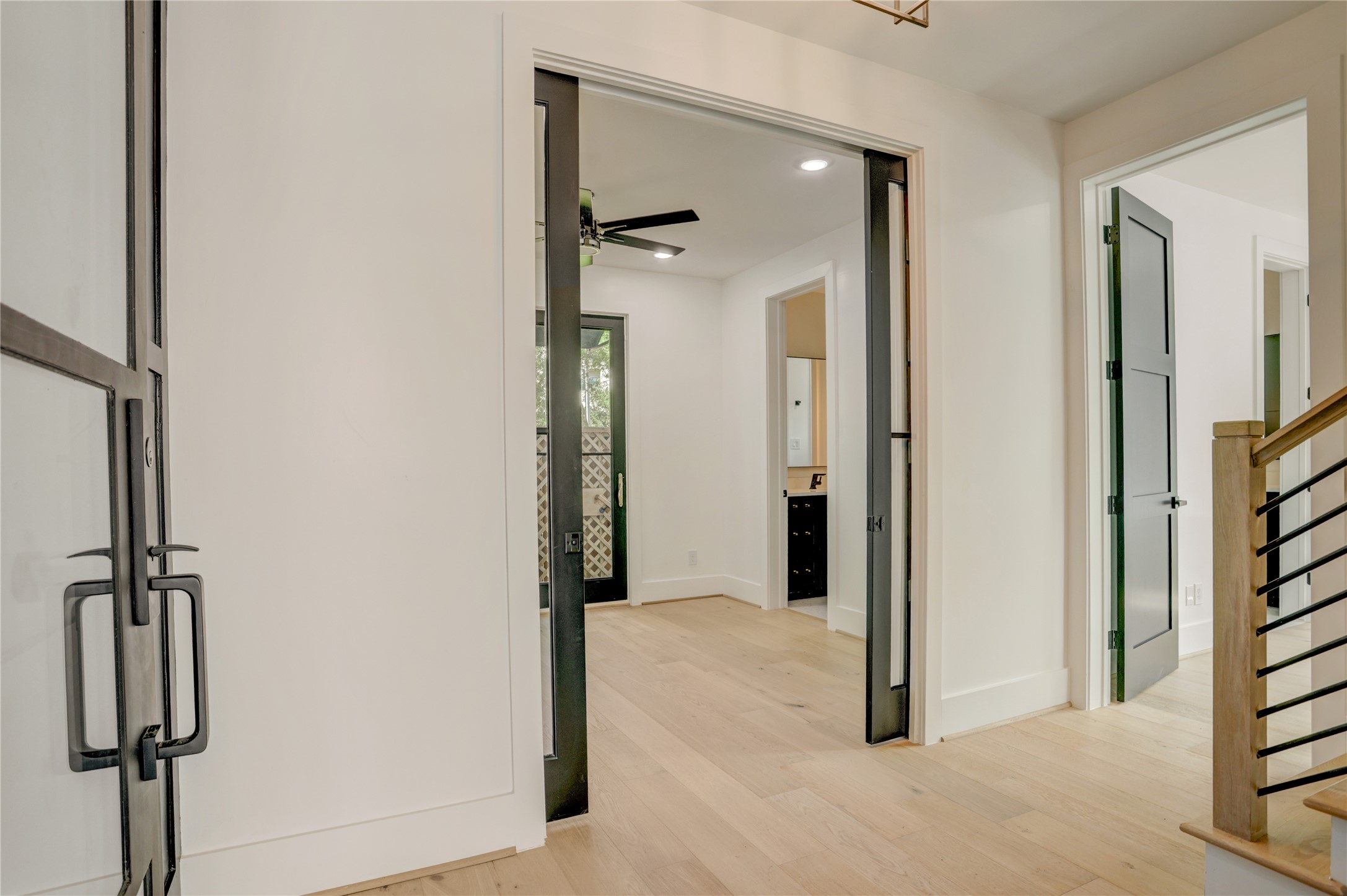 View as you enter the home, showcasing the glass French door study/bedroom 4 and access to the first floor suite.