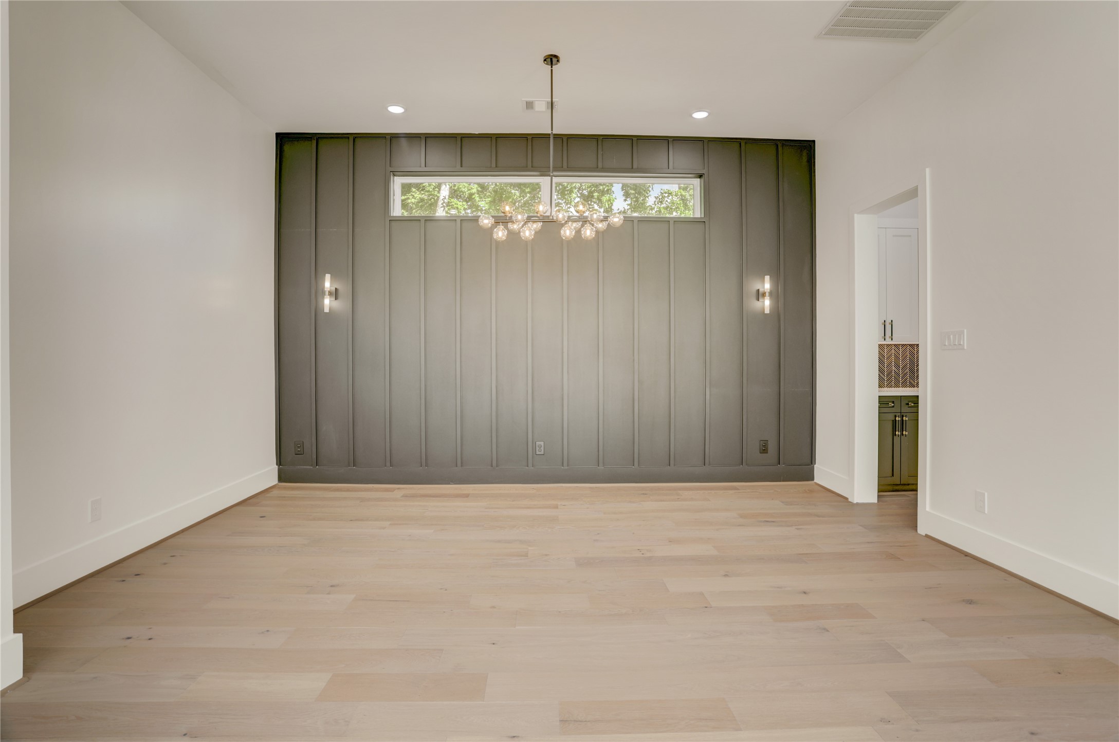 Completely open to the living area is a private dining room with stunning accent wall.