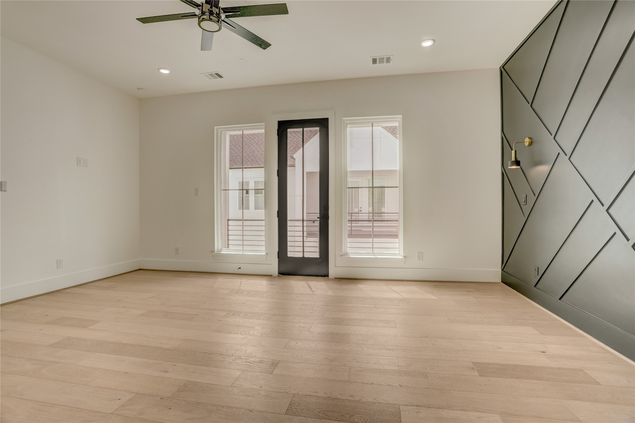 View of the primary bedroom from the bathroom entrance.