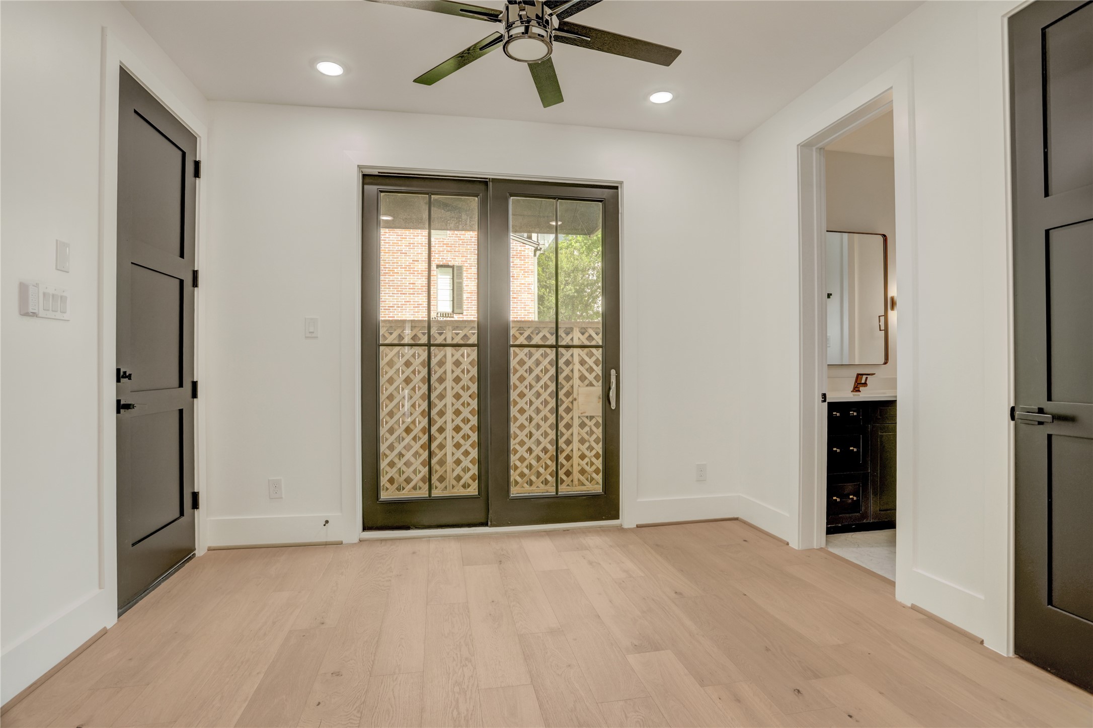 The first-floor study/bedroom 4 offers ensuite bathroom access and glass doors to the backyard.