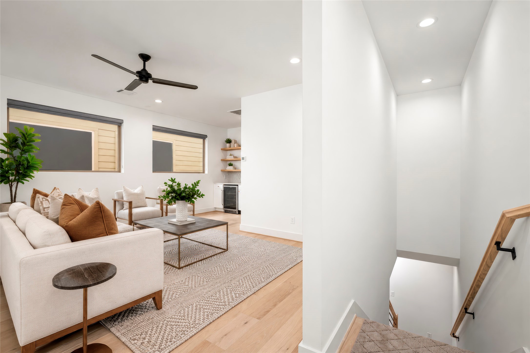 Third floor gameroom with engineered wood floors, two large windows filling the room with natural light, ceiling fan, dry bar with storage and shelves has potential for many different uses.  Mother-in-law suite, media room gym?  Virtually rendered.