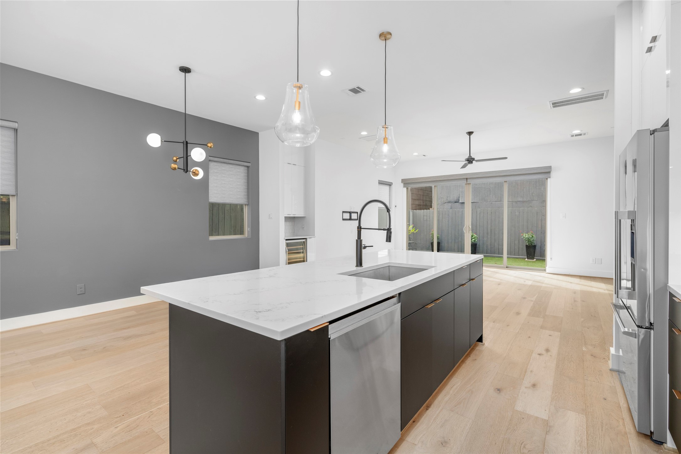Kitchen with views of the dining room and living room beyond.  Fisher & Paykel dishwasher conveniently located in the island.