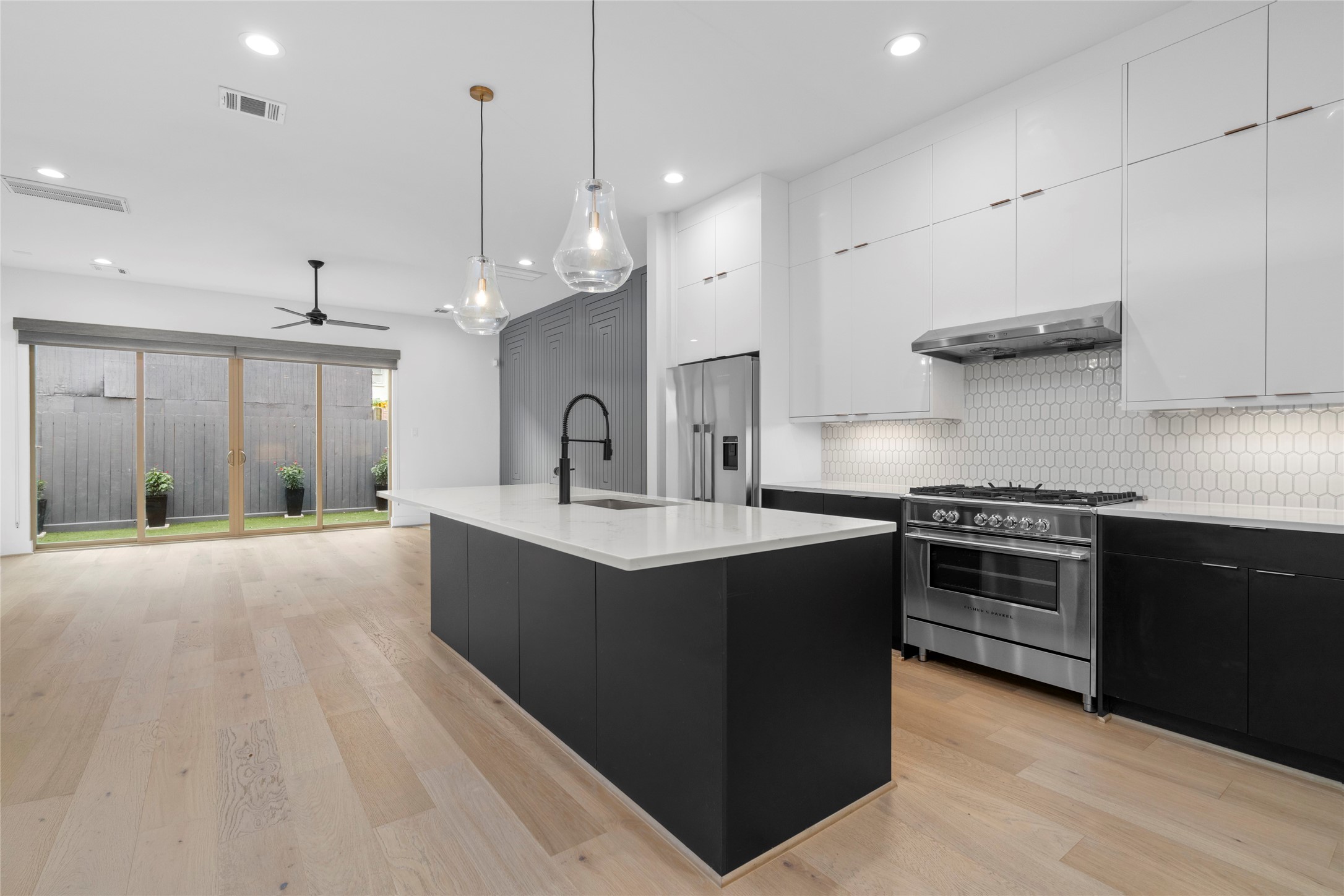 Light and bright with recessed lighting, pendants over the island, stainless steel under mount, single bowl sink. Easily seat four at the breakfast bar.