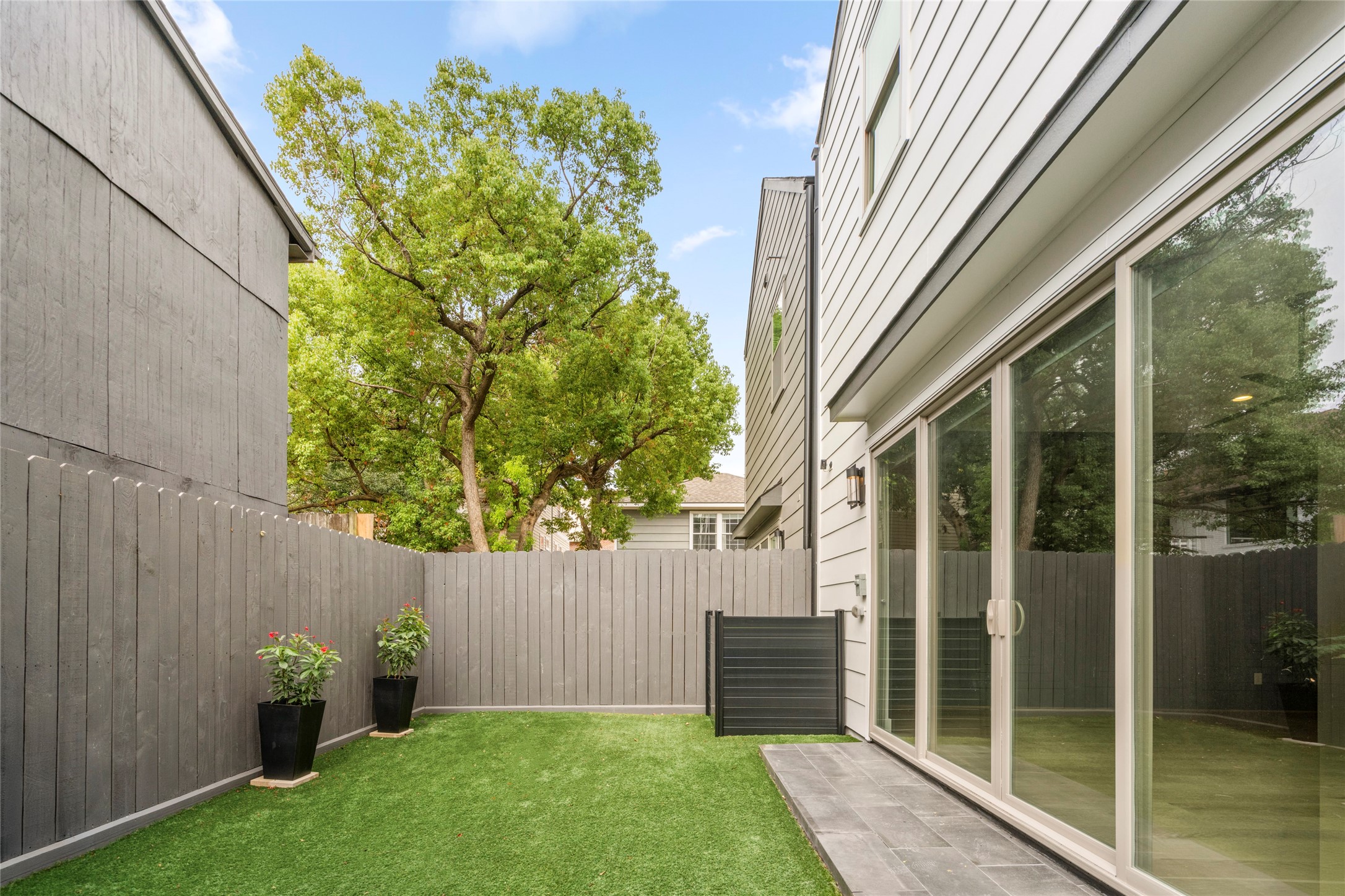 Turfed backyard is fully fenced with AC enclosure.  Porch just off the living room for easy grilling.