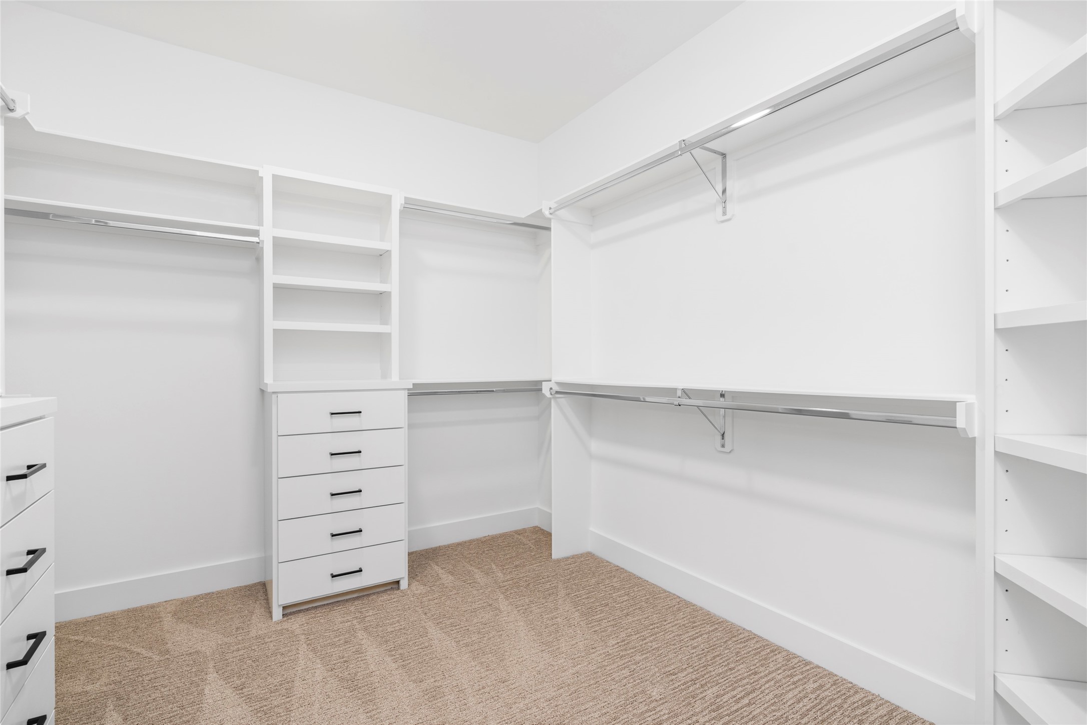 Per builder, professionally designed closet with built-ins, adjustable and metal rods.