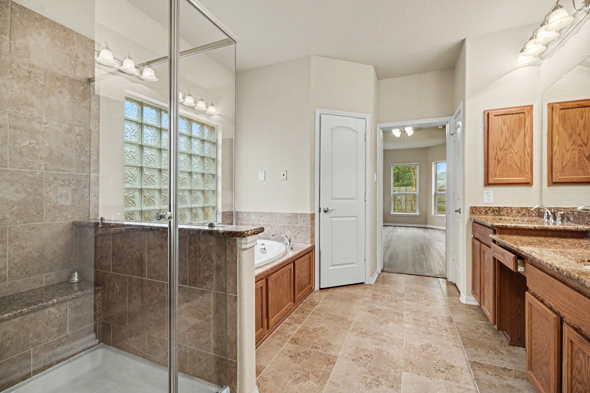 Do you prefer bubbles or steam?  A glass enclosed shower with bench seat or an oval garden tub stands ready for you to wash away the cares of the day!