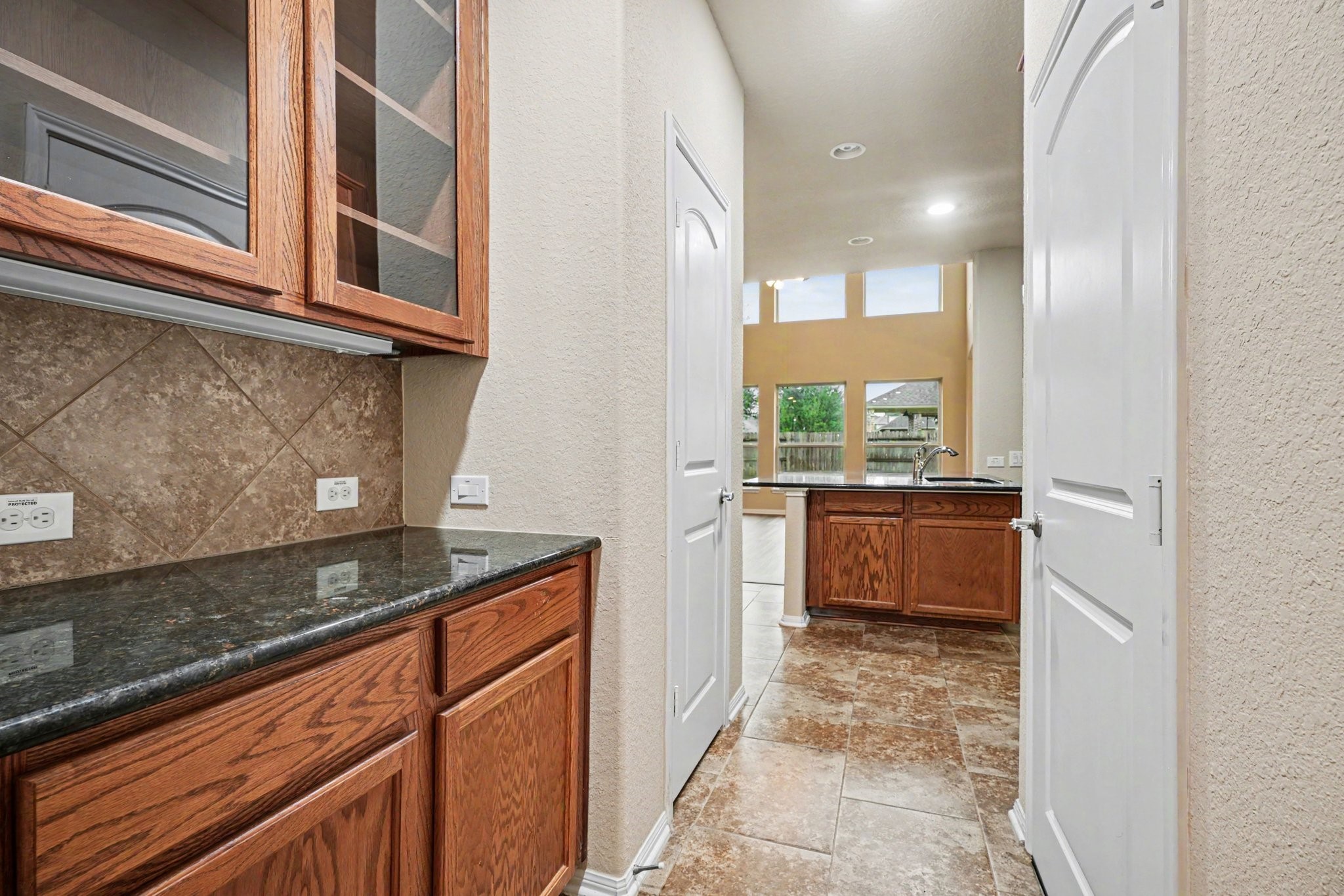 A butler's pantry perched between the kitchen and family room is ideal for a coffee or beverage bar!
