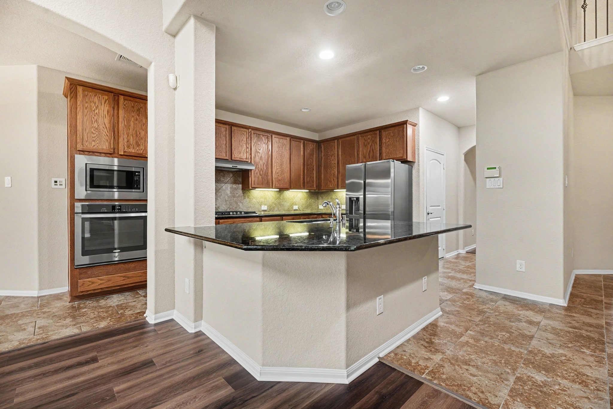 This kitchen boasts warm cabinets offering lots of storage space for the chef of the home!
