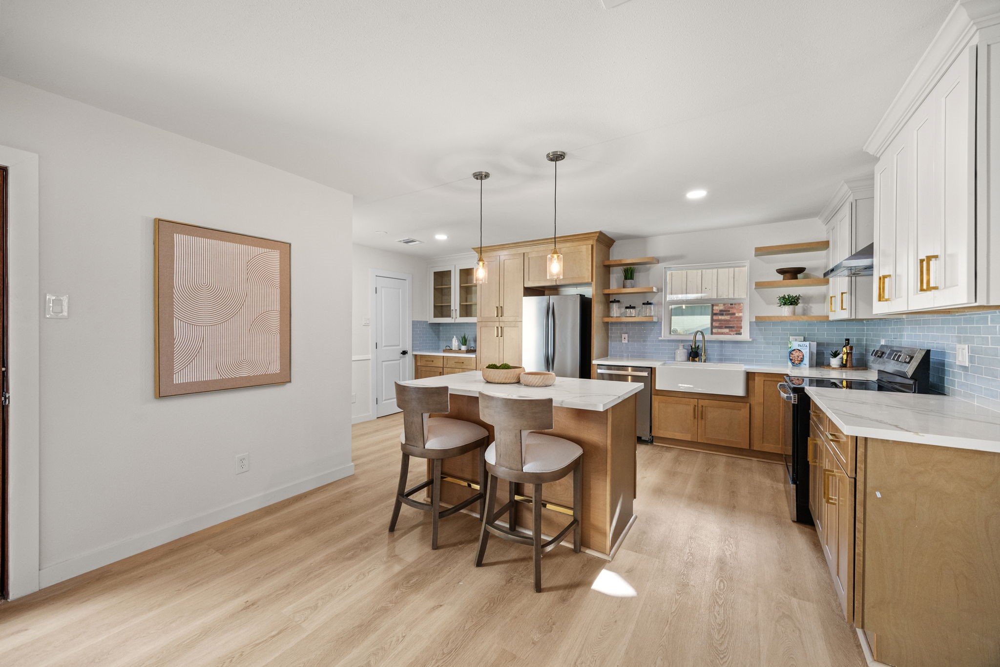 Tastefully remodeled kitchen with new stainless steel appliances and farmhouse sink. Tastefully remodeled kitchen with new stainless steel appliances and farmhouse sink.