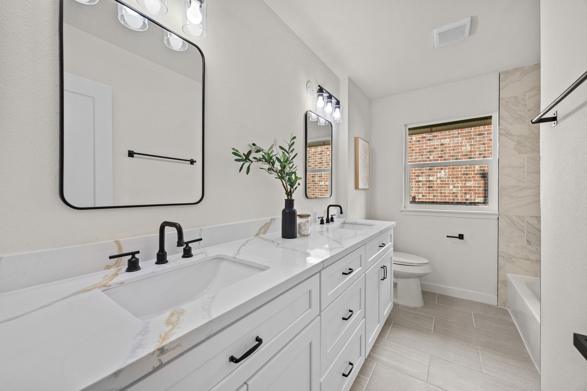 Secondary bathroom features double sink and garden tub