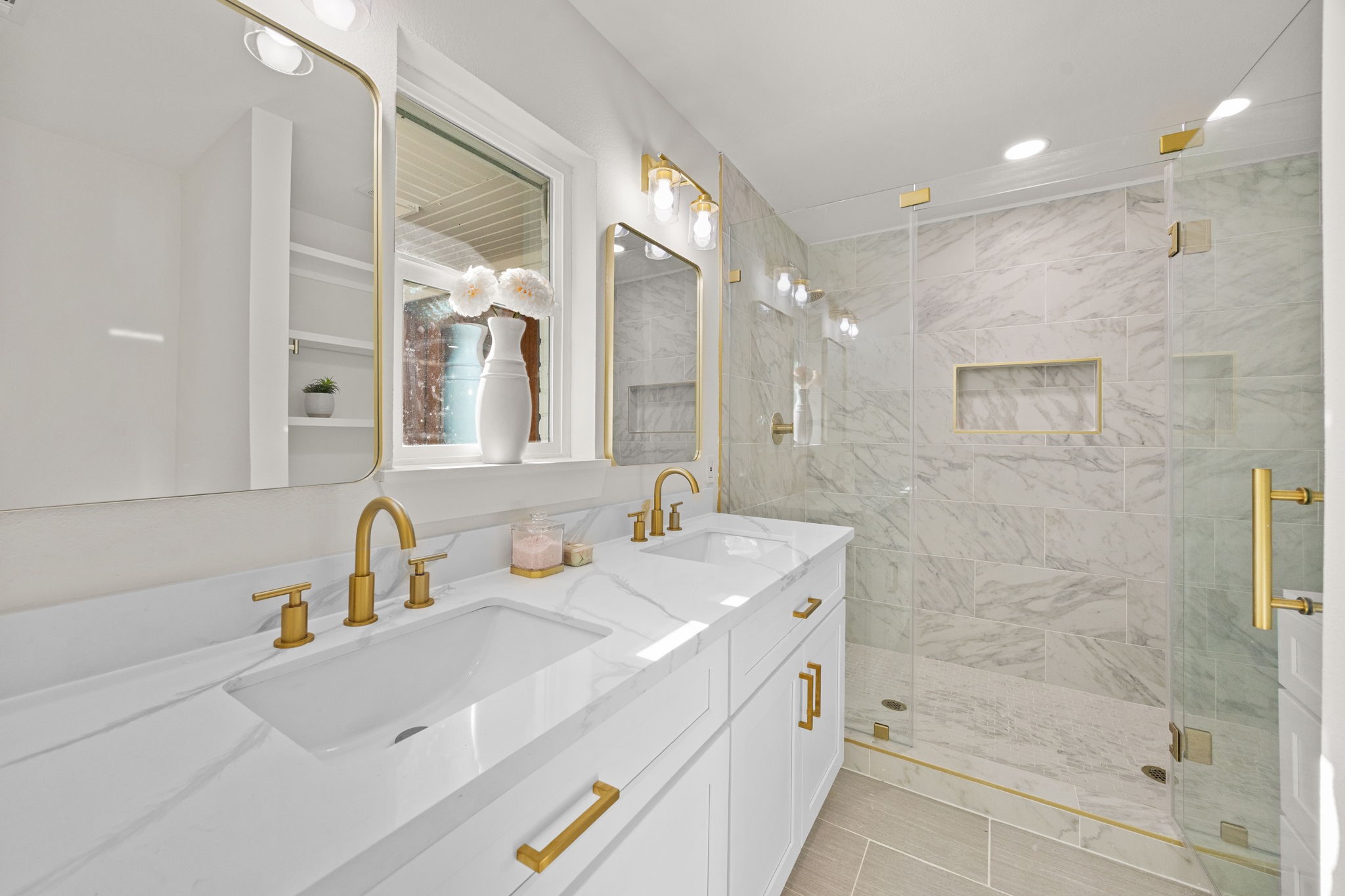 Primary ensuite features oversize shower with 2 shower heads, double sinks and built-in shelf