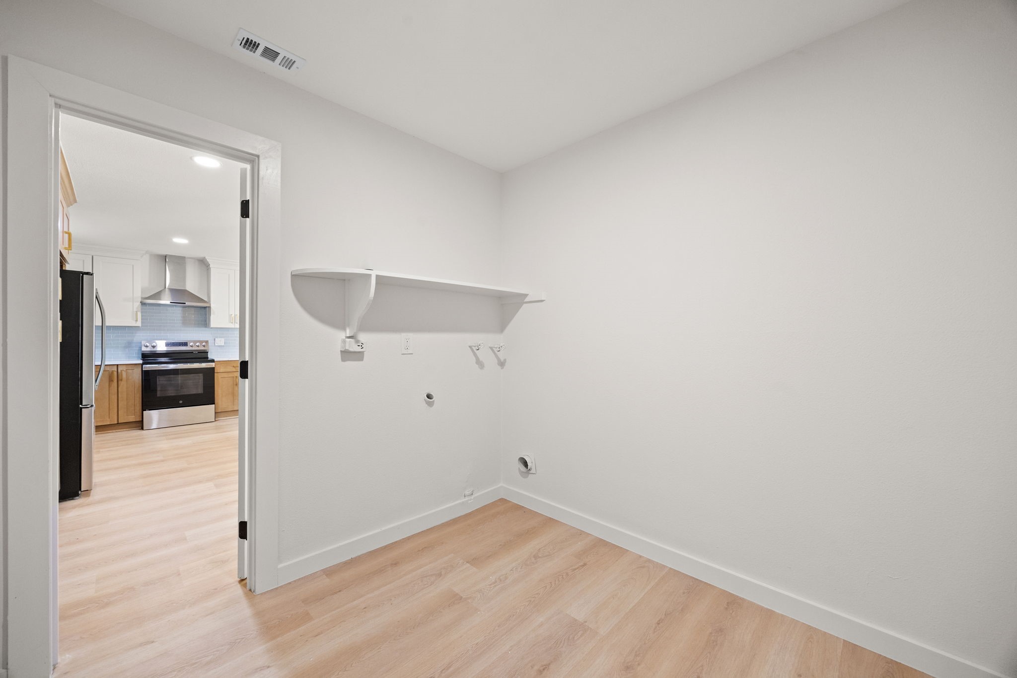 Laundry room in house with built-in closet