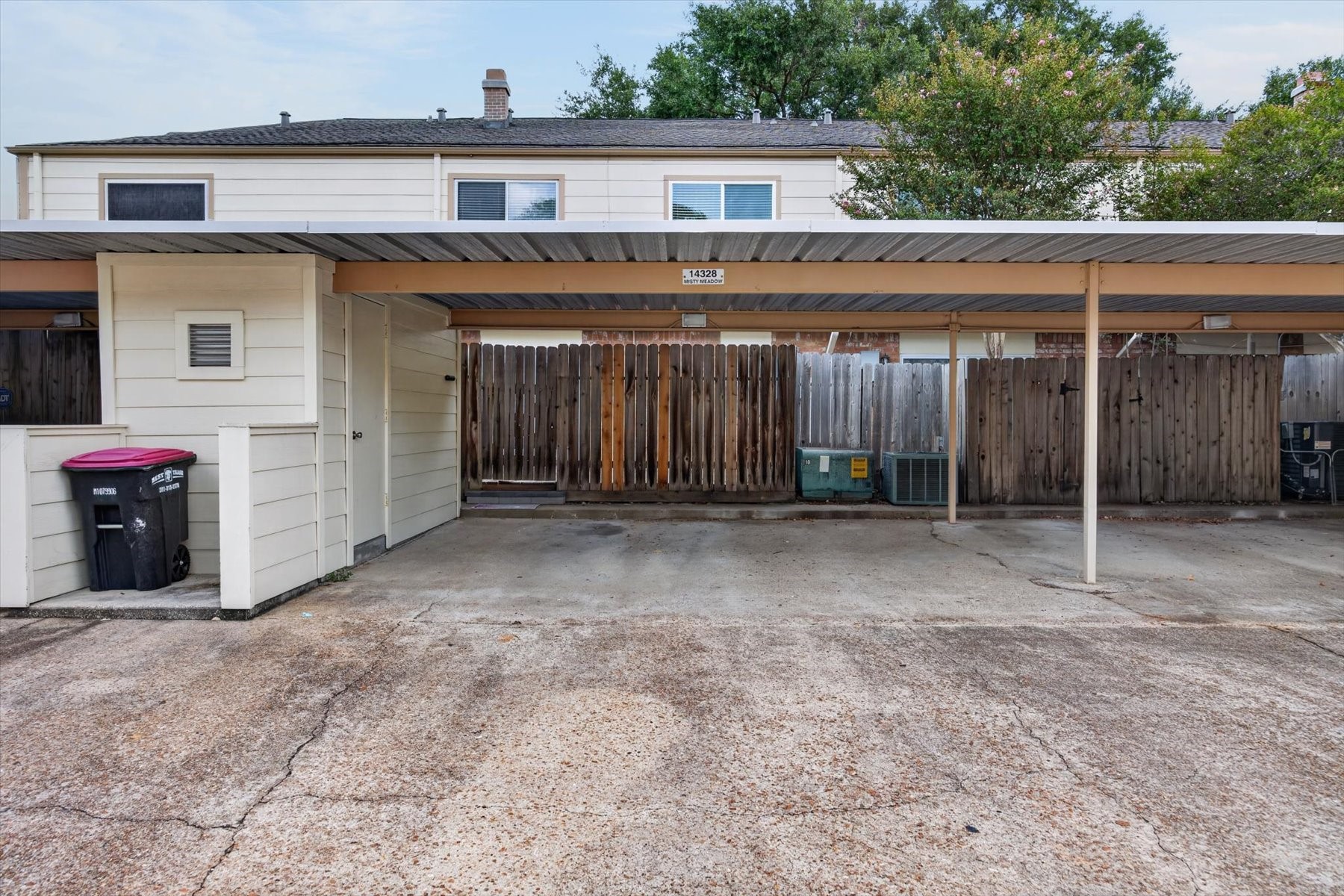 Outdoor storage space and carport with two spaces.