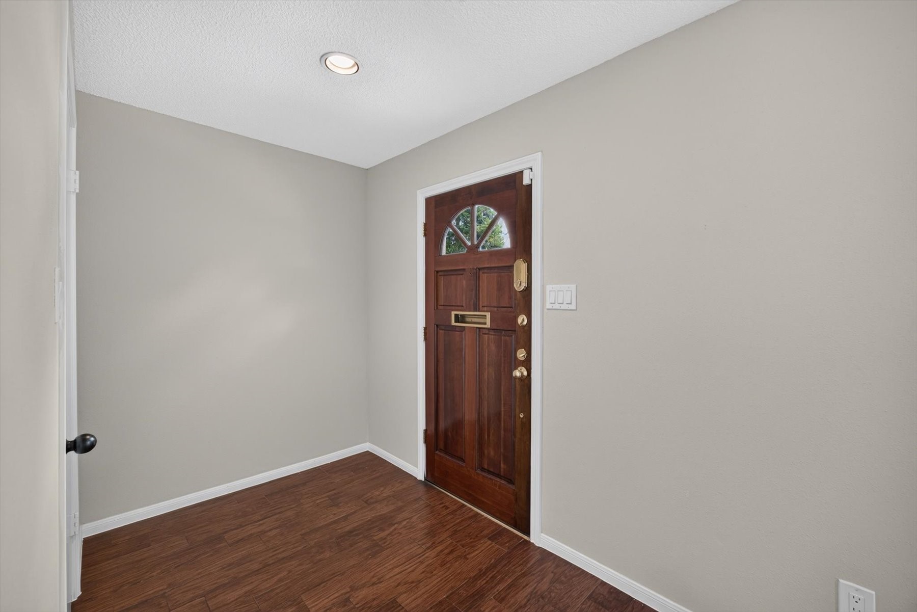 Freshly painted interior with wood-look tiled flooring throughout.