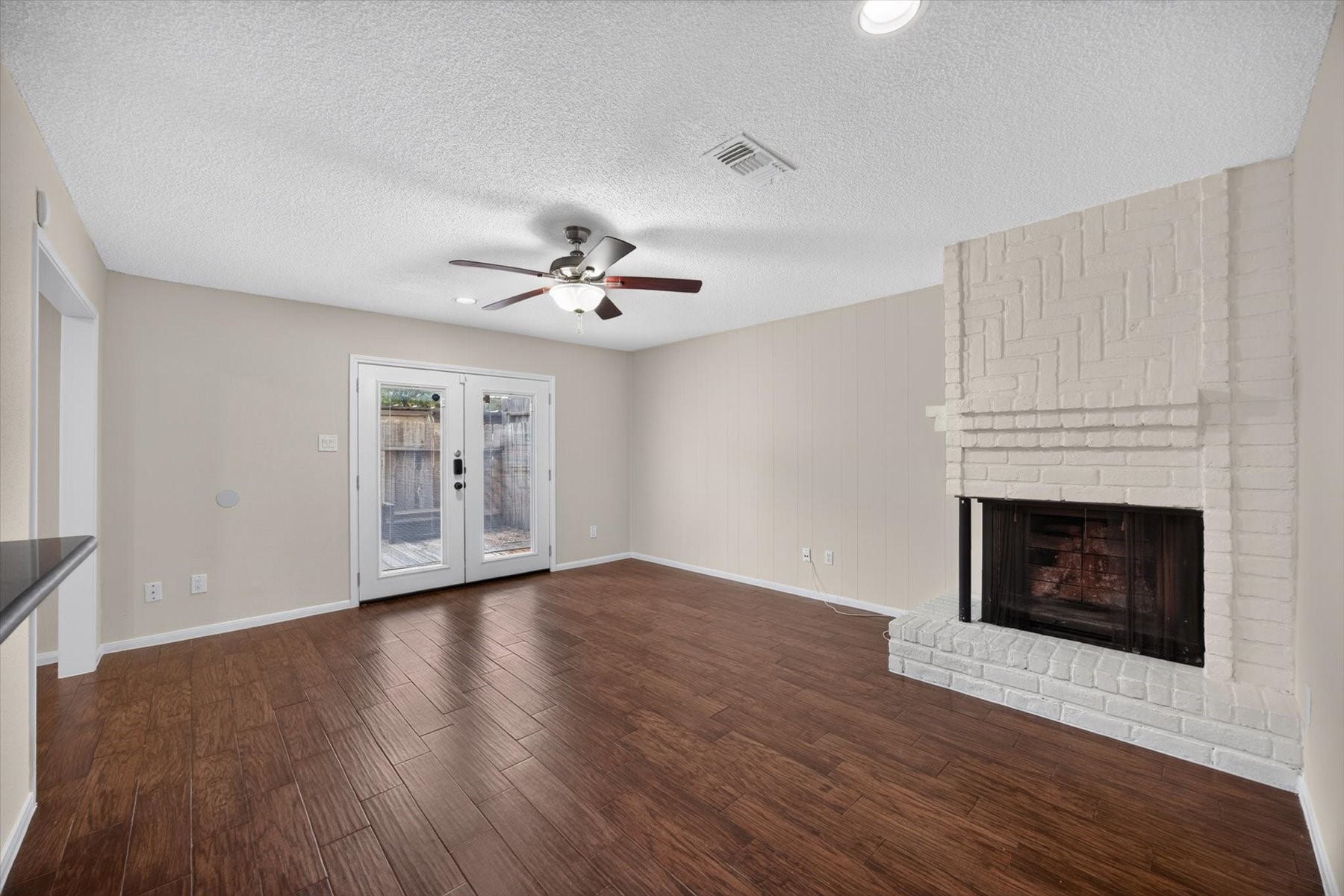French doors off fully fenced and private back patio area. Two-sided fireplace offers charm and a cozy space for you to relax or perhaps a formal dining space. Endless possibilities!
