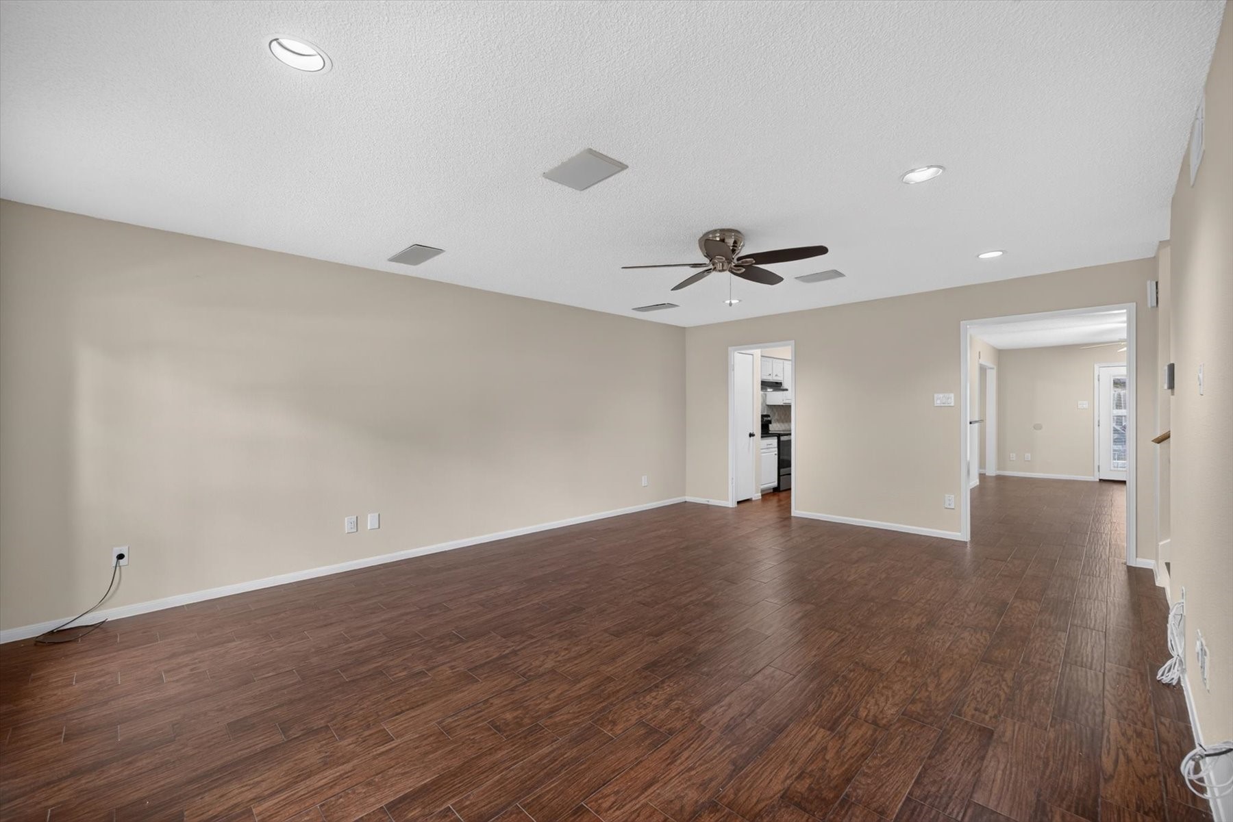 Living room has been freshly painted with updated lighting and a ceiling fan. Plenty of natural light flowing through the home.