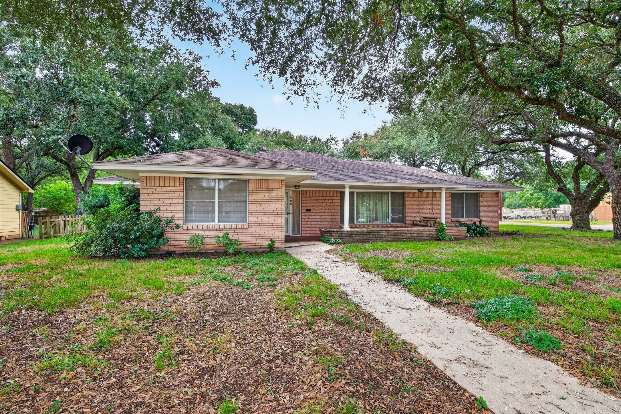 Front of the home surrounded by mature oak trees Front of the home surrounded by mature oak trees