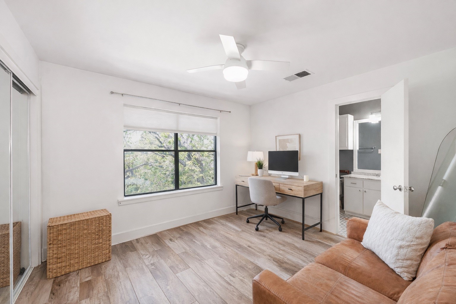 This inviting secondary bedroom offers a cozy and versatile space, perfect for guests or family, with ample natural light and a functional layout.