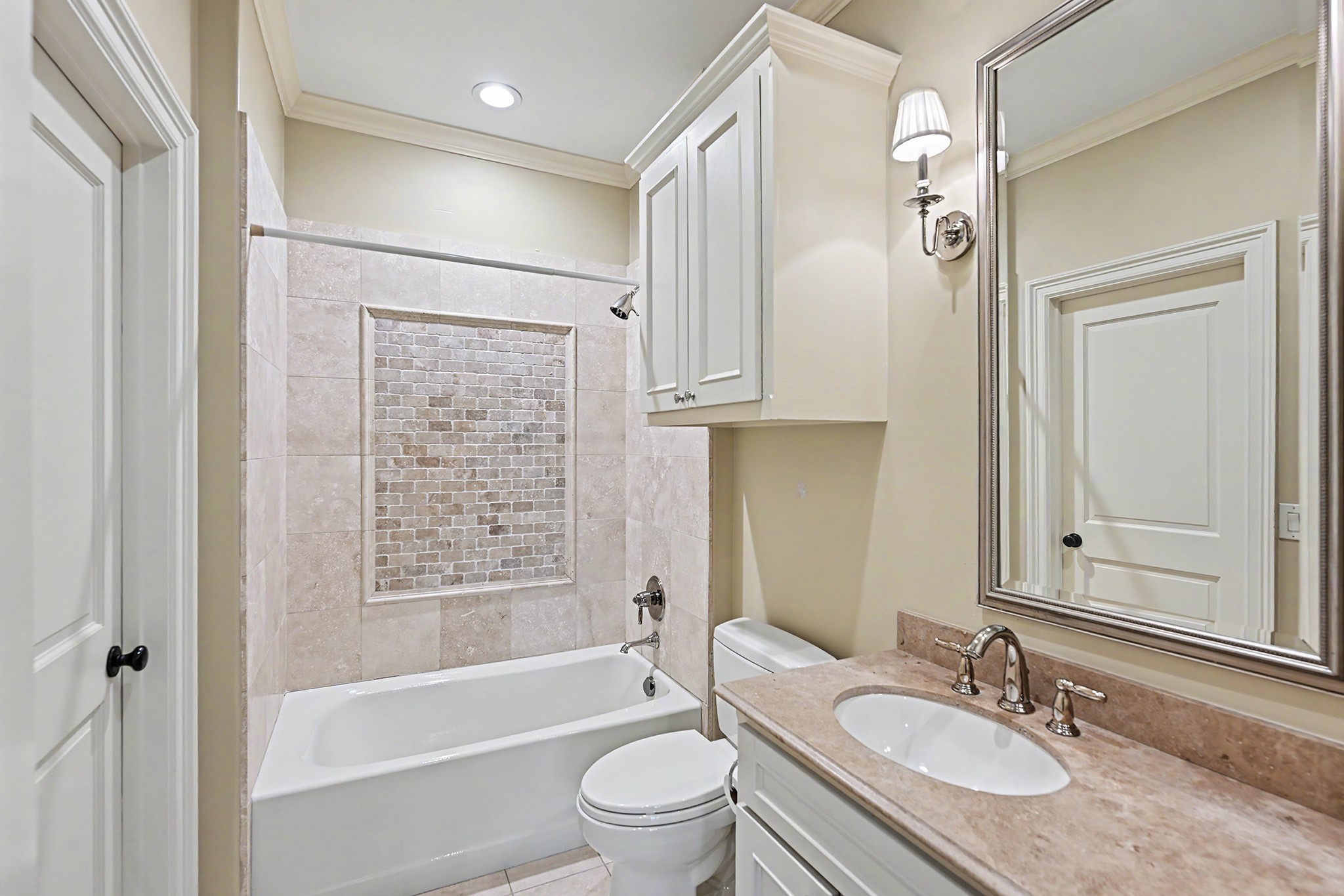 Ensuite bathroom has a tub/shower combination and neutral finishes.