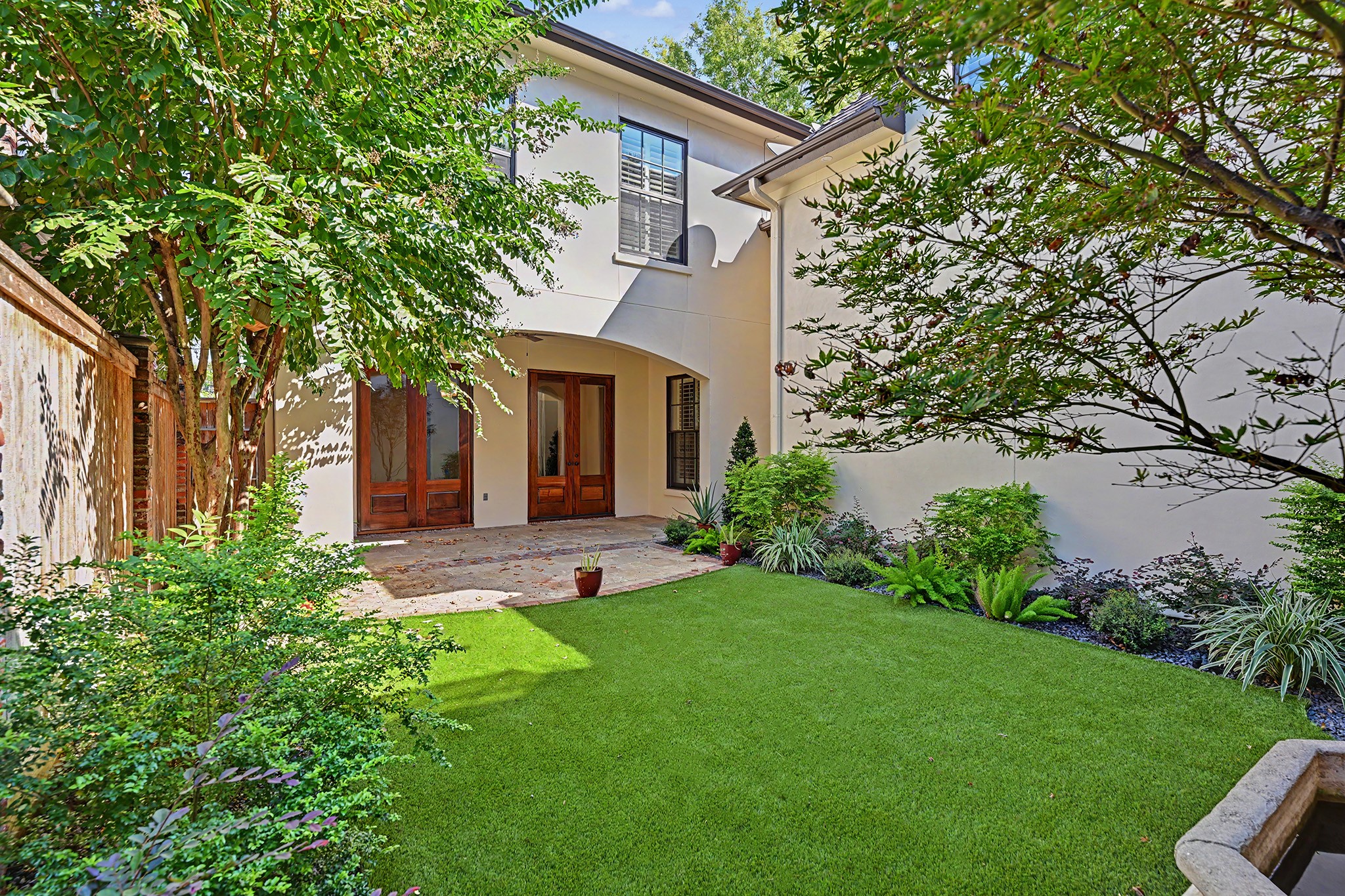Entertain or relax outdoors in the private, fenced backyard with covered patio and a lovely landscaped setting.