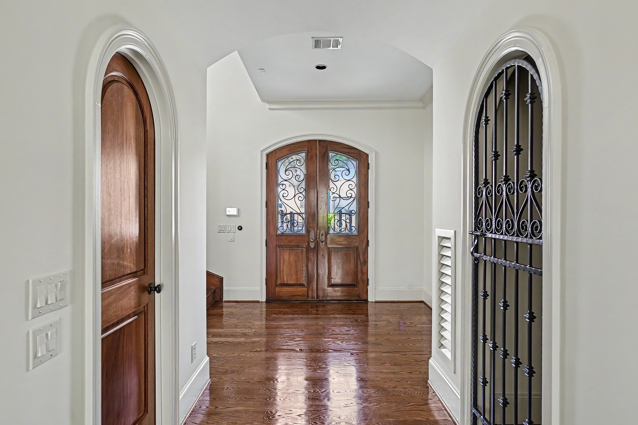 View toward the entry, with a dedicated wine room to the right and a conveniently located powder room to the left.