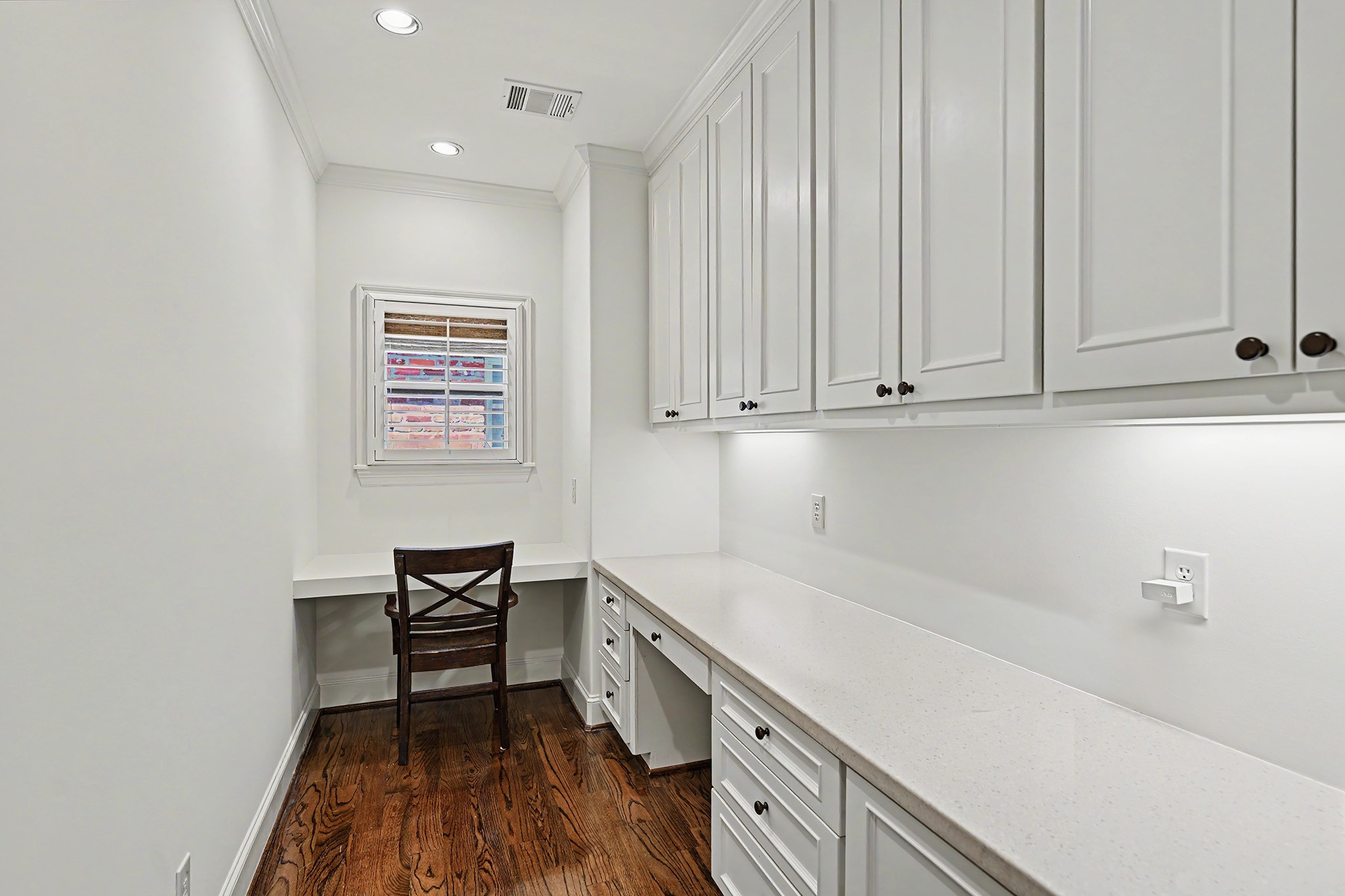 A private office within the primary suite includes a built-in desk and abundant cabinetry and drawers for convenient storage and organization.