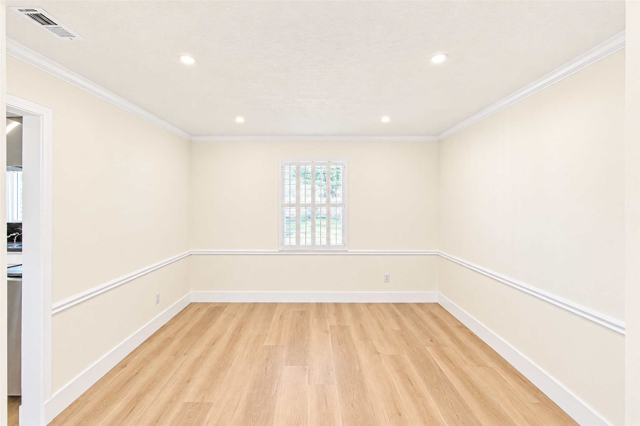 Bright and inviting, this dining room features elegant vinyl flooring and soft natural light, creating the perfect setting for memorable gatherings.