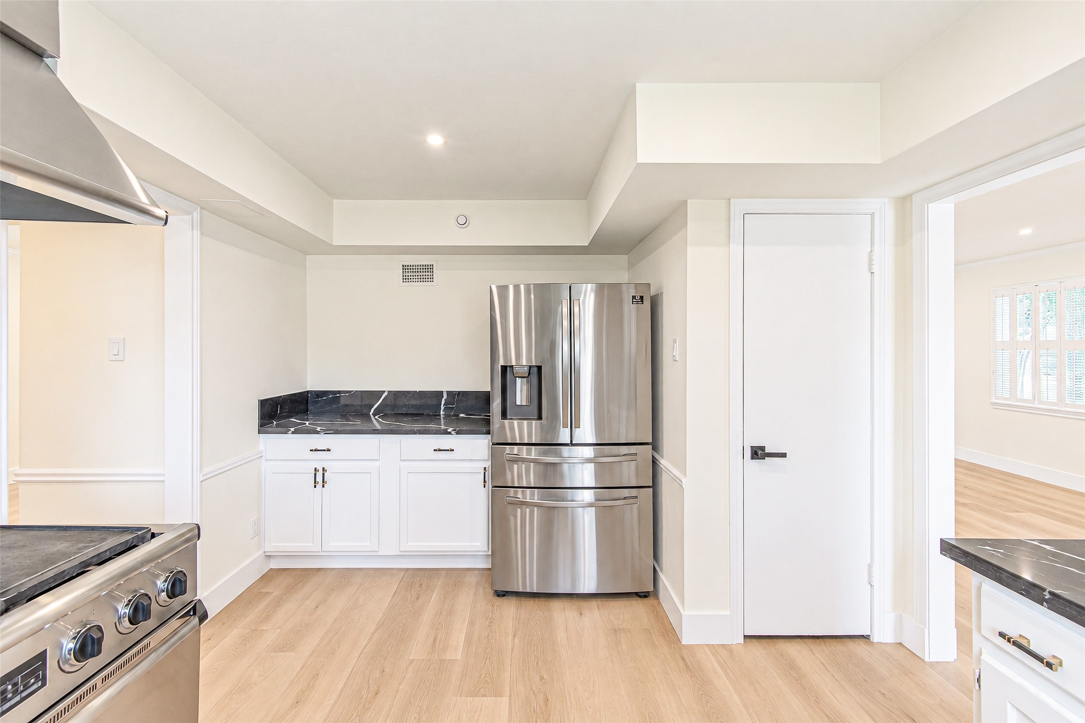 Modern kitchen with sleek stainless steel appliances, ample cabinetry, and elegant quartz countertops.