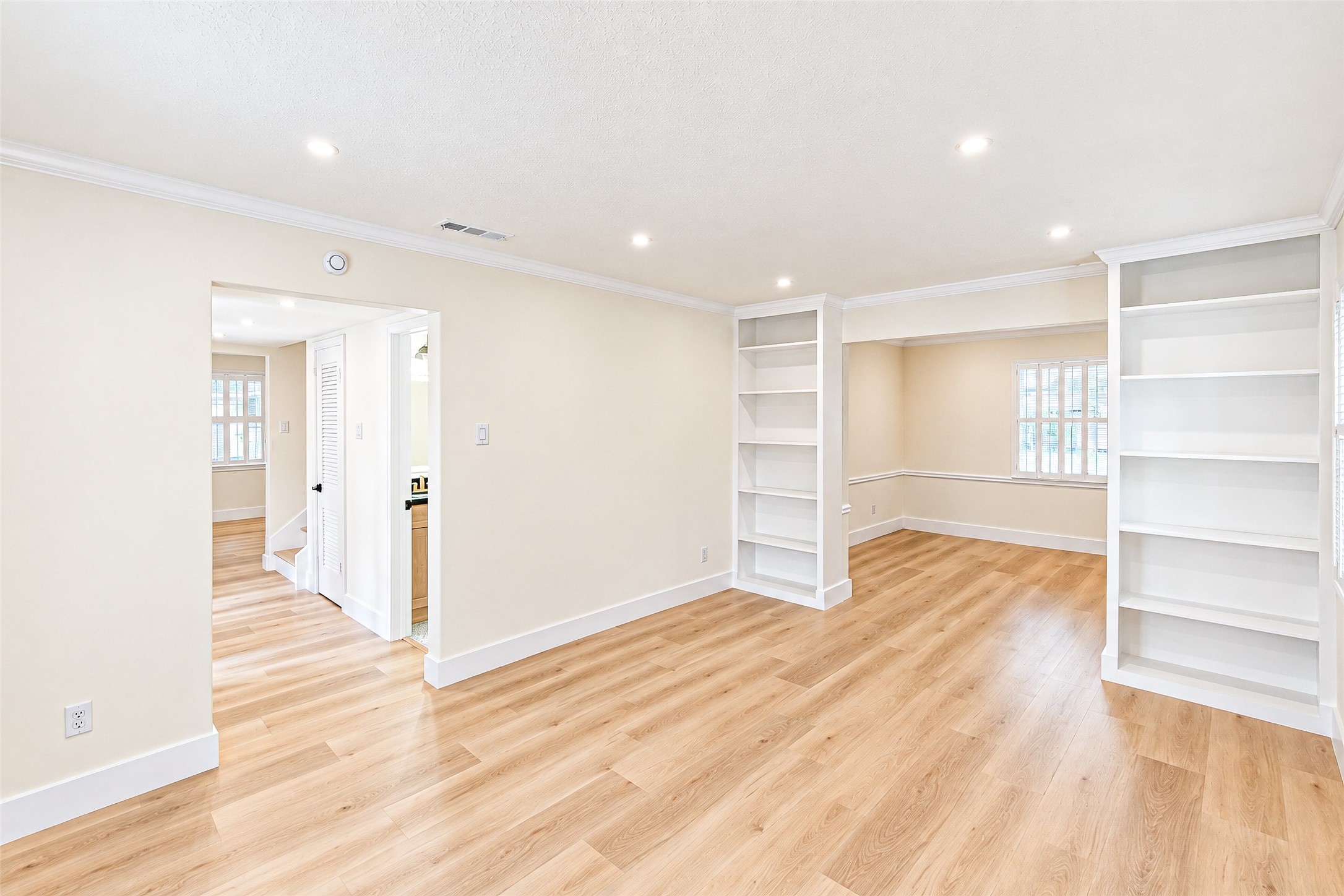Discover a bright and inviting study with sleek built-in bookshelves, perfect for focus and inspiration.