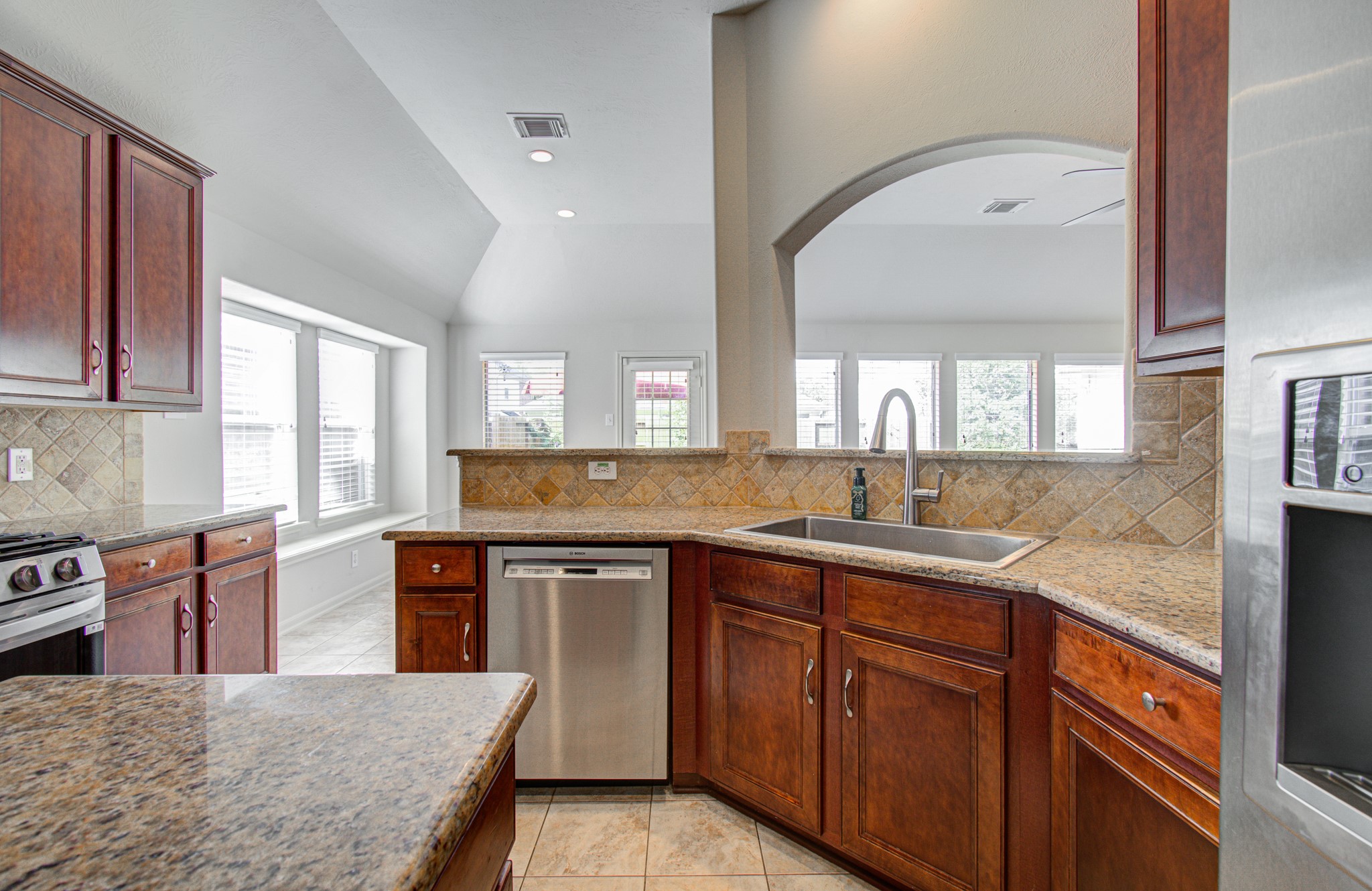The open layout features ample natural light and a charming arched passthrough.