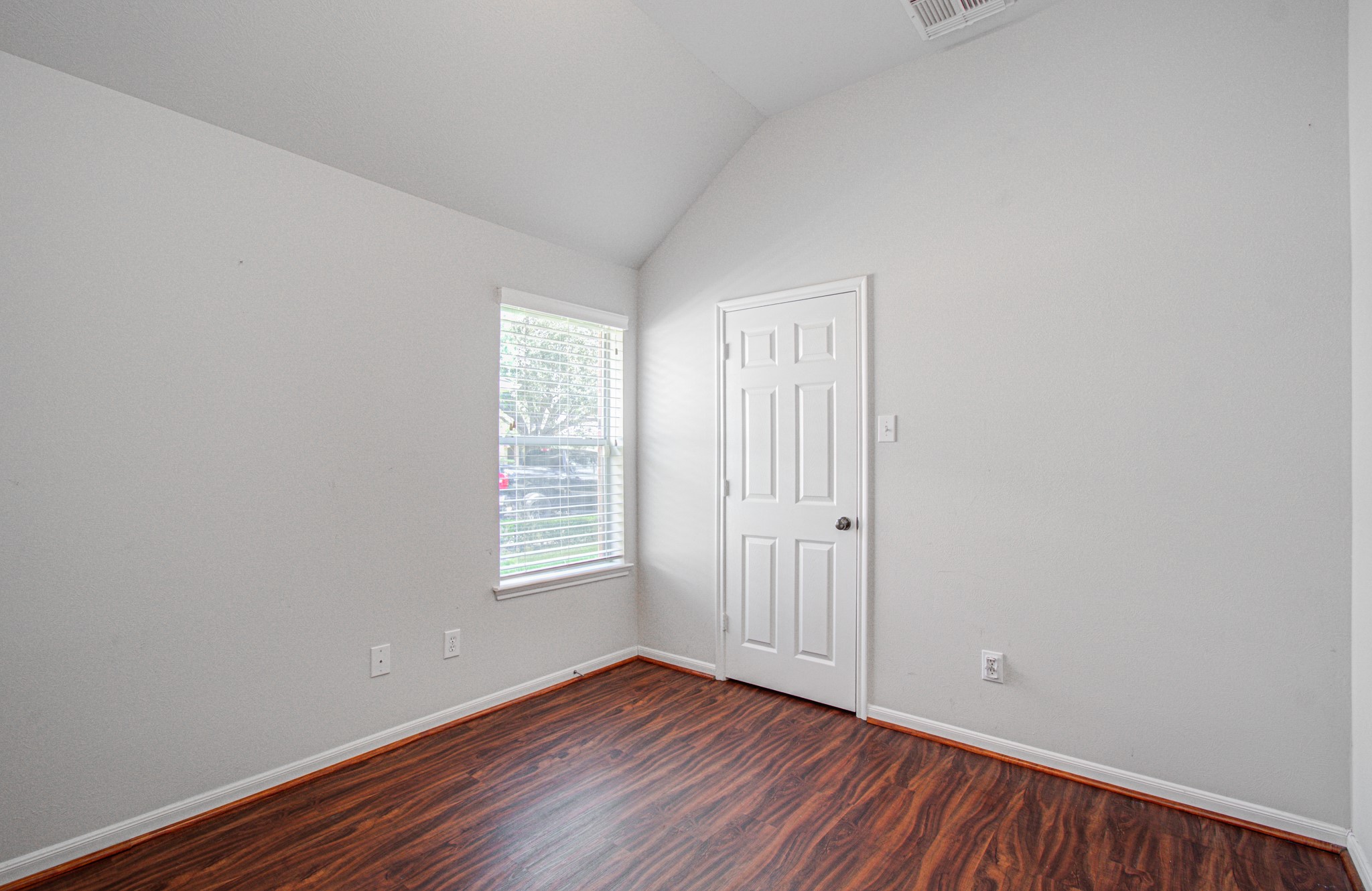 Secondary bedroom with high ceiling and spacious closet.