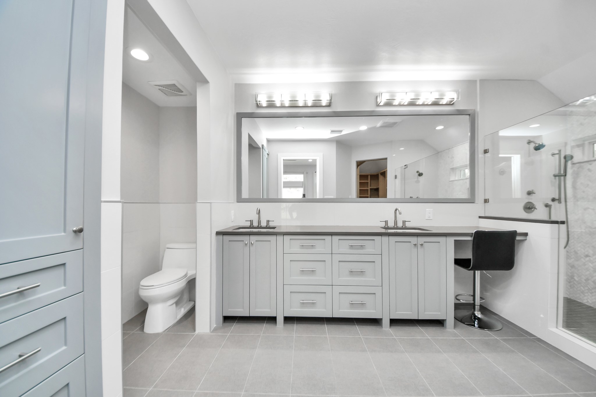 Primary bathroom with quartz countertops, all soft close solid wood custom cabinetry