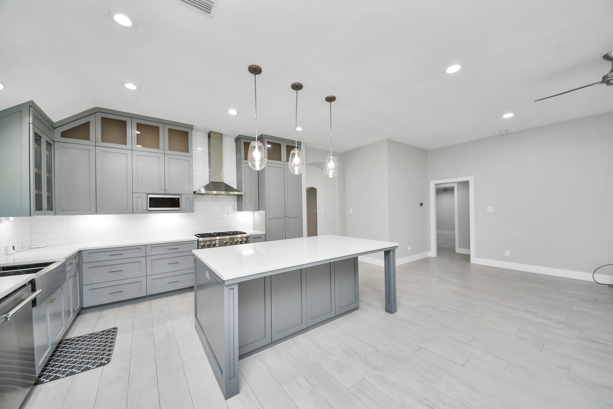 A chefs dream of a kitchen! Open concept and guaranteed to wow with soft closing custom solid wood cabinetry, Thermador 6 burner range, built in microwave, seamless quartz countertops, pendant lights and a vent hood to blow away all your steam.