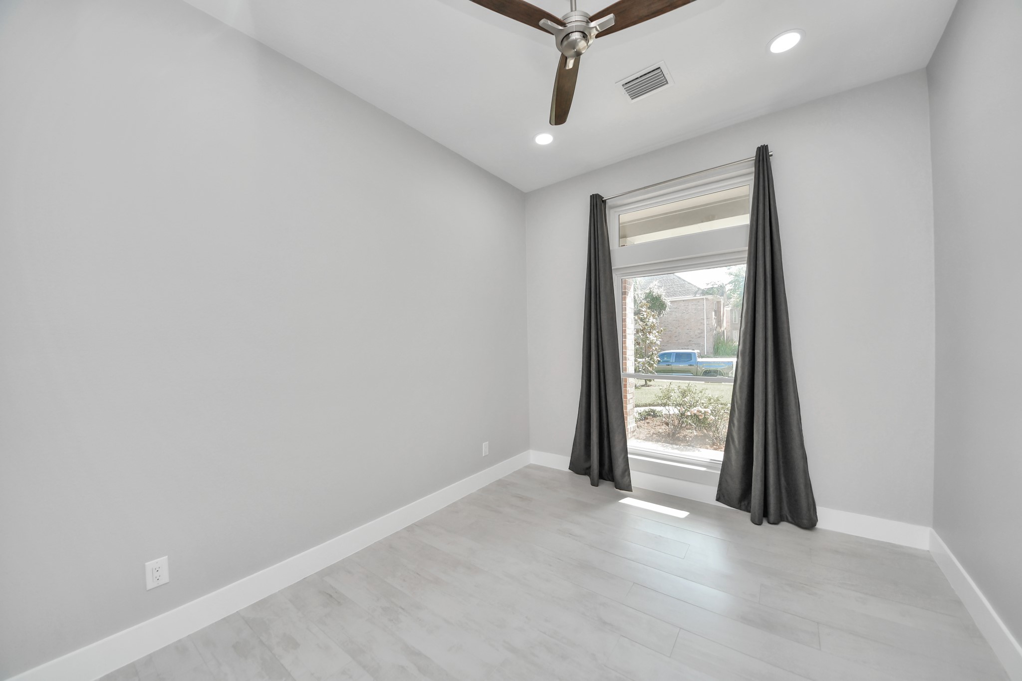 Guest bedroom with updated lights and a upgraded fan