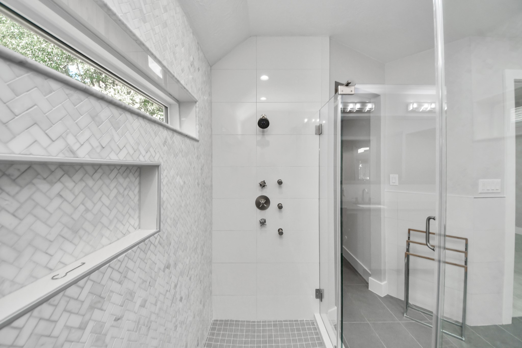 Luxurious custom shower in the primary bedroom featuring body sprayers, wands and custom set temperature controls on both sides for the perfect shower, every time!