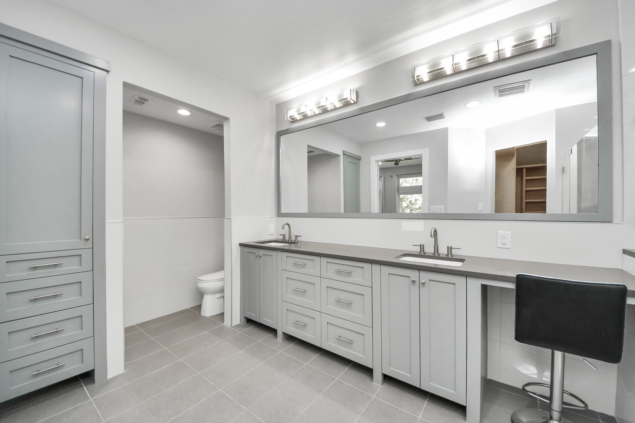 Primary bathroom with quartz countertops, all soft close solid wood custom cabinetry